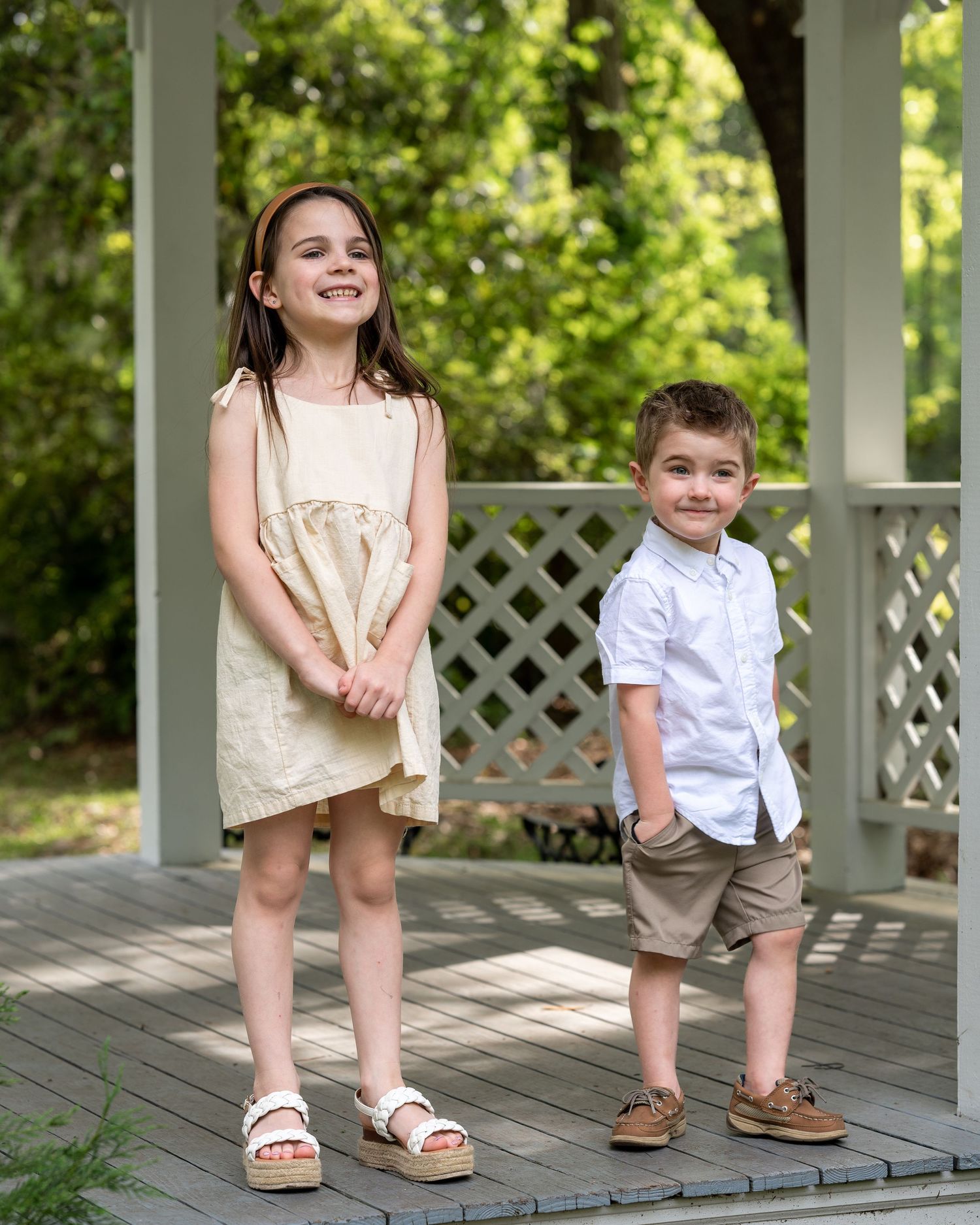 Lilly and Nathan stand under a gazebo giving their parents silly faces
