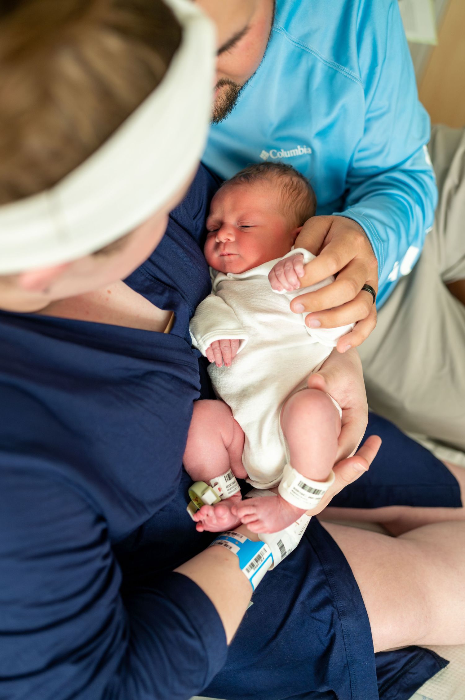Sarah and her husband cradle their newborn son in Sarah's hospital bed during a Fresh48 session