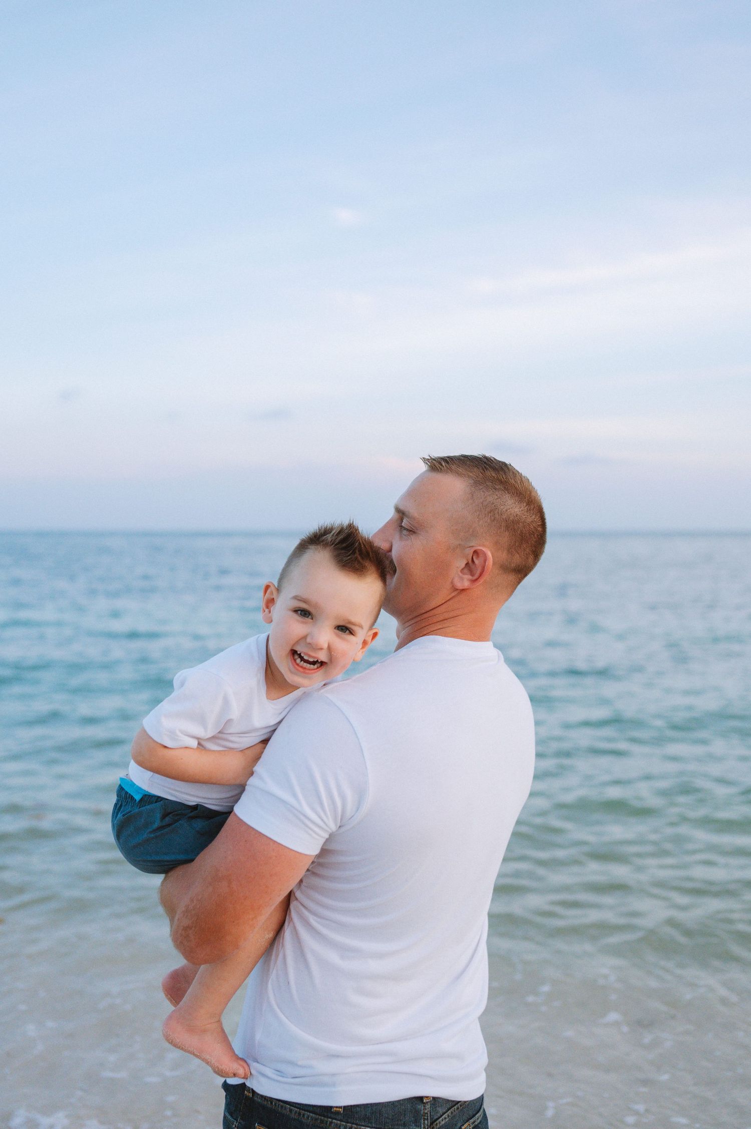 Key West family photographer capturing sunset beach portraits with warm golden light and ocean backdrop