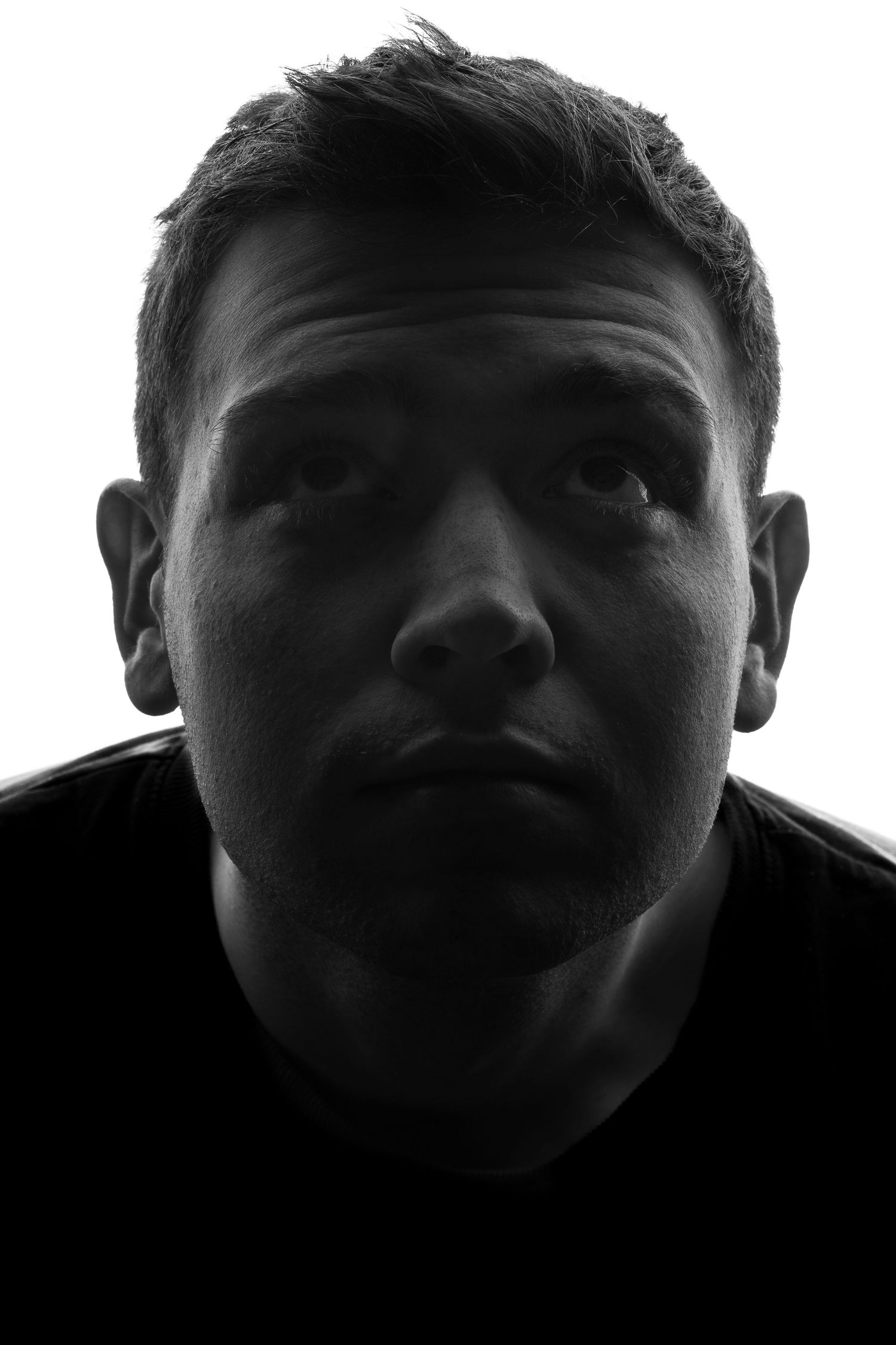A dramatic series of five silhouette portraits against a dark background showing different angles and expressions.