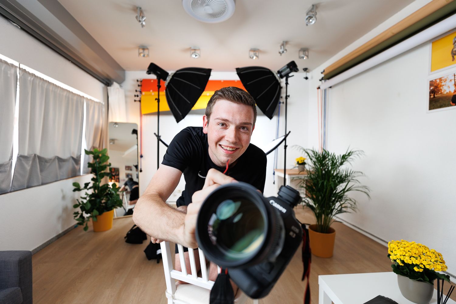 Photography studio setup with lighting equipment and white backdrop.