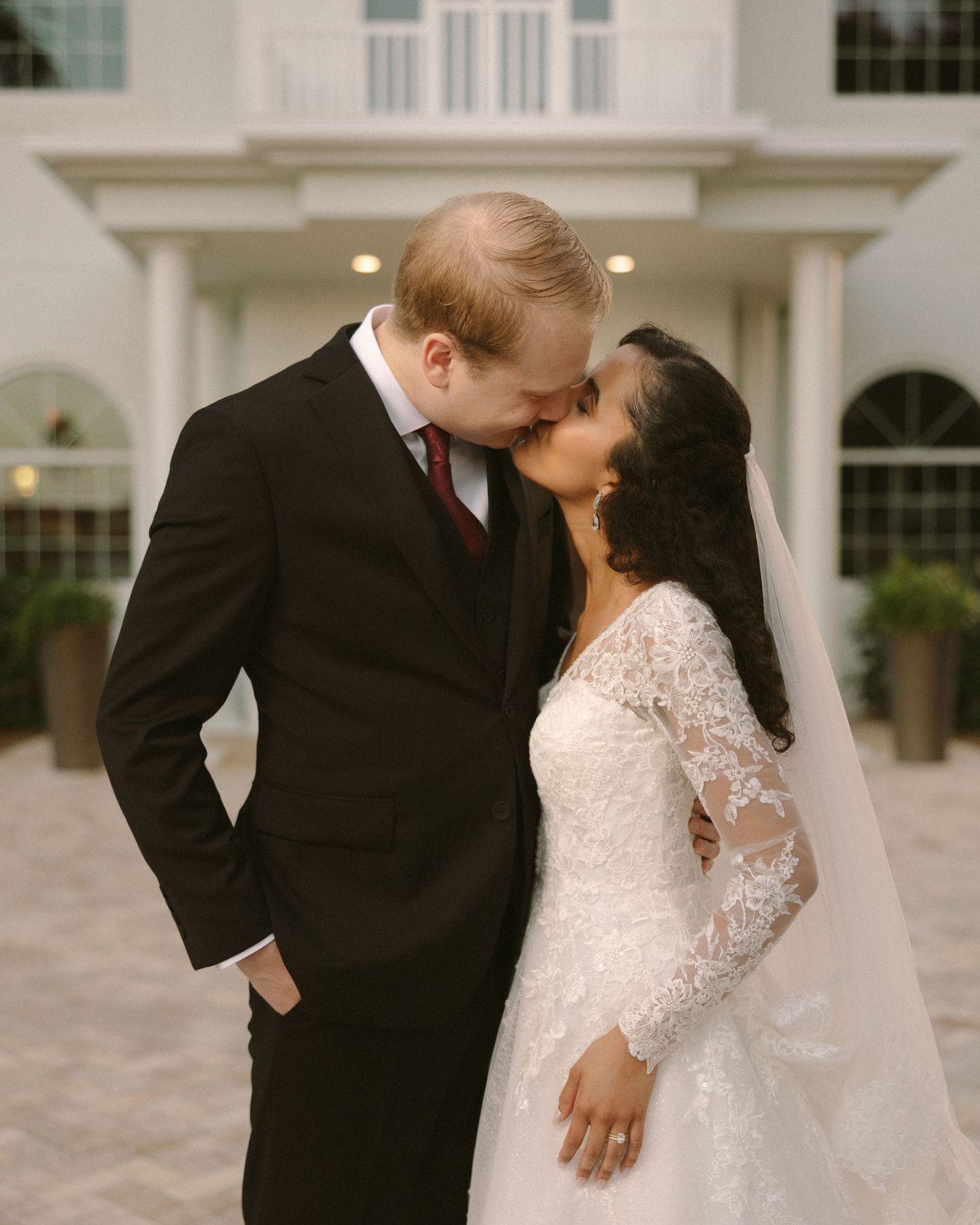 Newlyweds share their first kiss during the ceremony exit, surrounded by cheering guests.