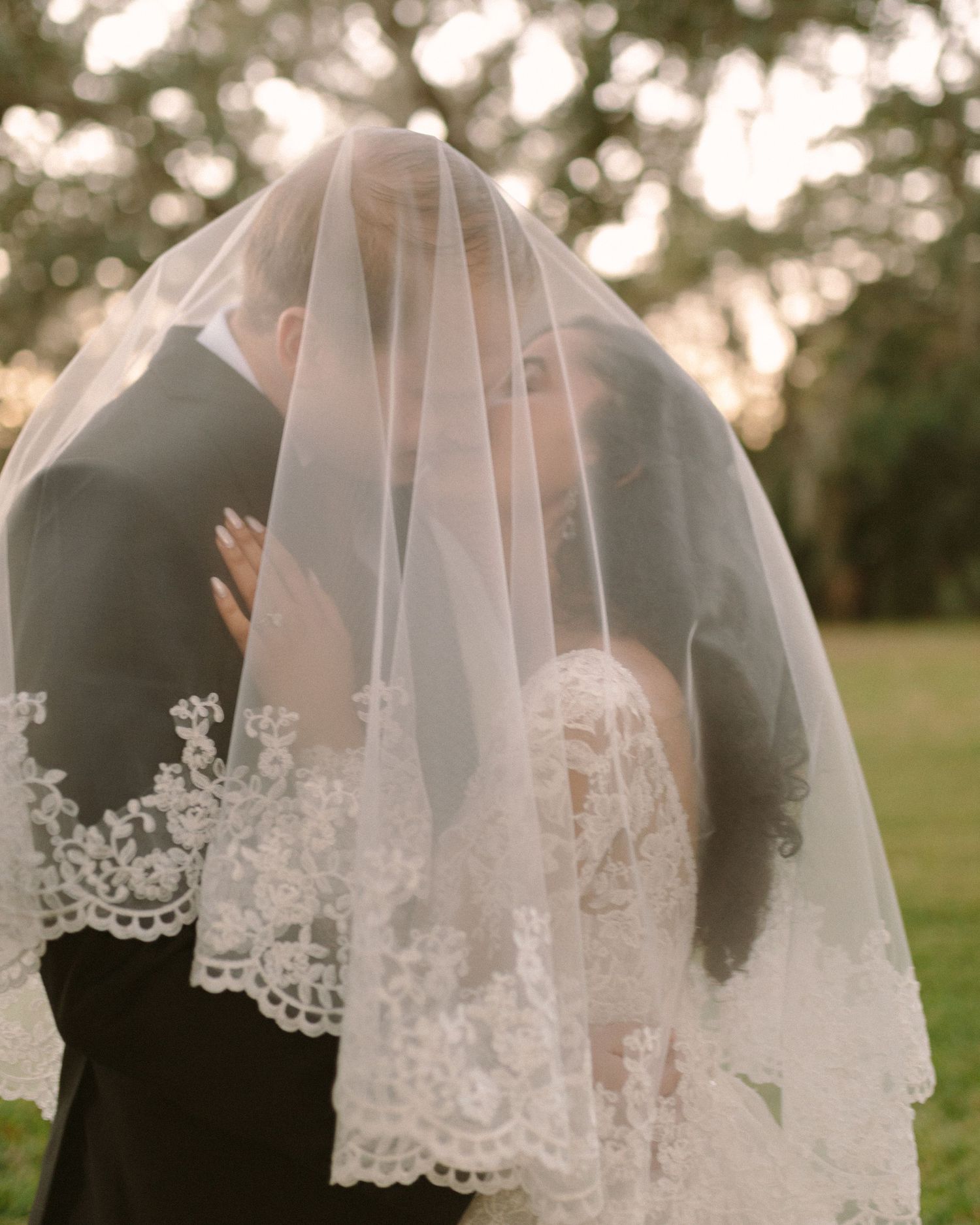 Newlyweds share their first kiss during the ceremony exit, surrounded by cheering guests.