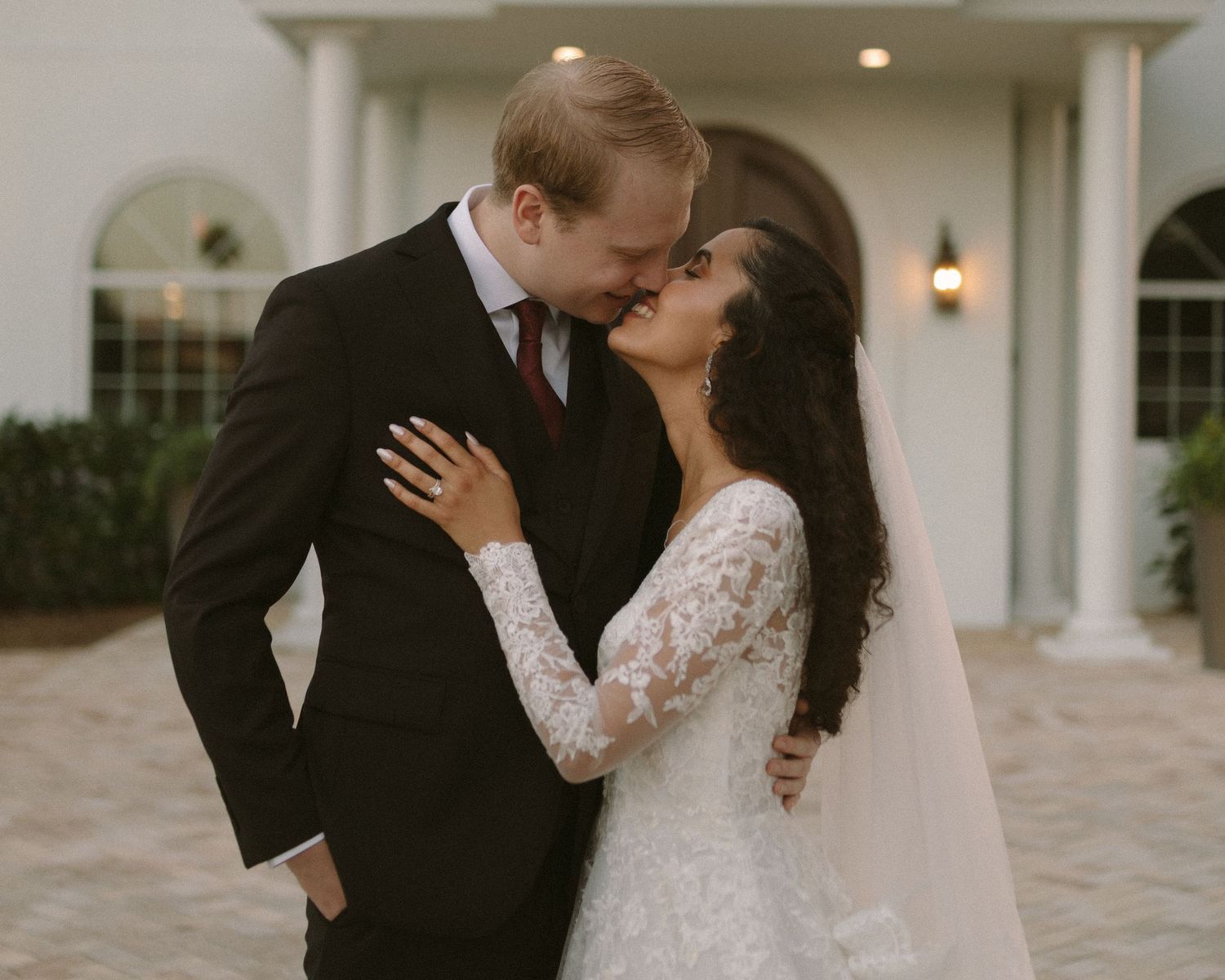 Newlyweds share their first kiss during the ceremony exit, surrounded by cheering guests.