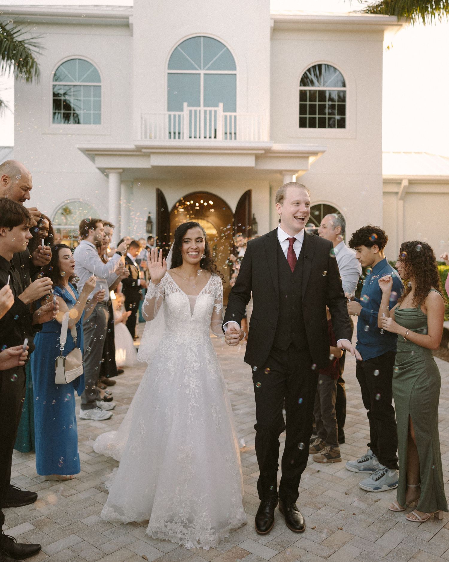 Bride and groom walk down the aisle together after the ceremony, celebrating with friends and family.