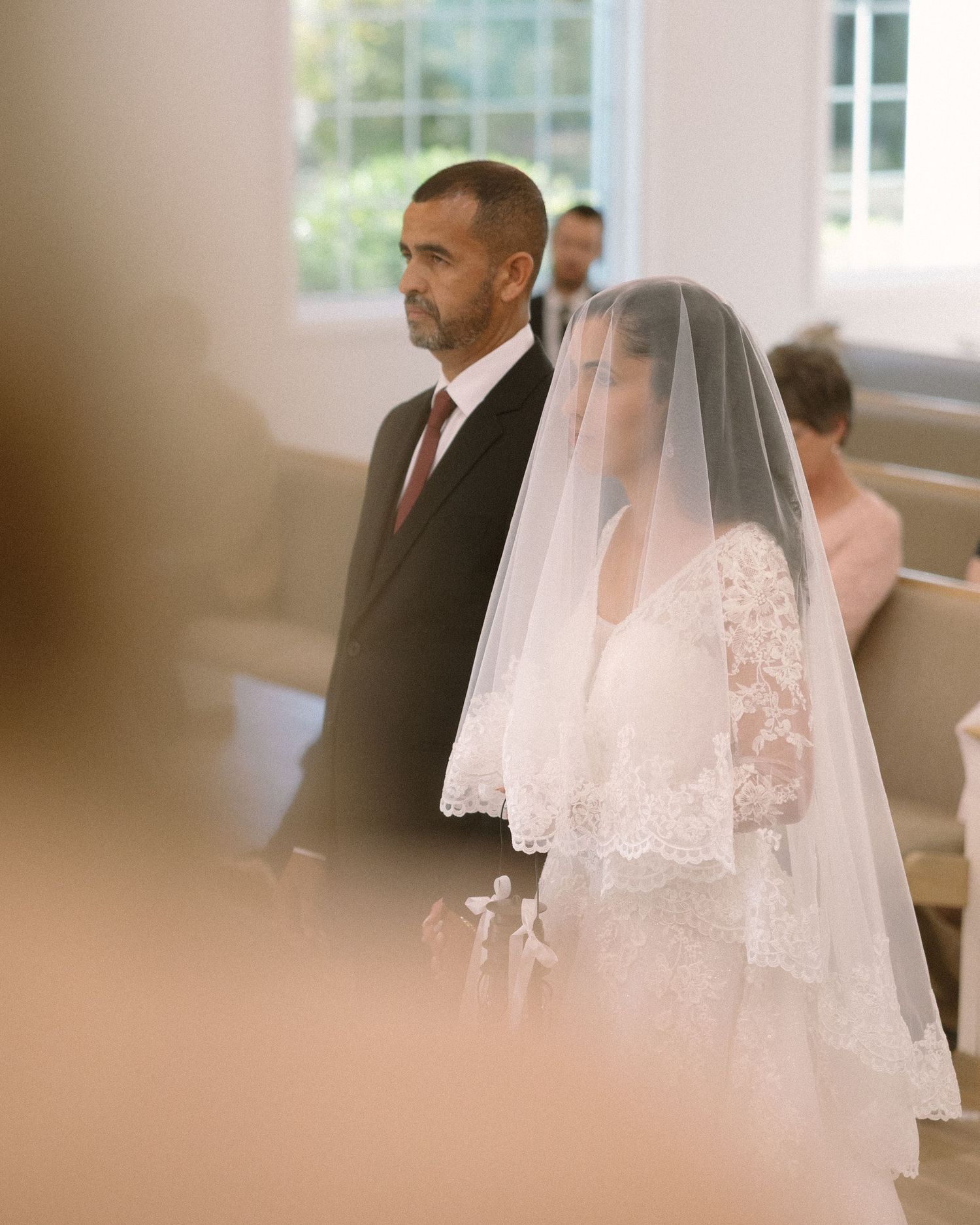 Bride is guided down the aisle and handed off during the ceremony, a meaningful and emotional moment surrounded by loved ones.