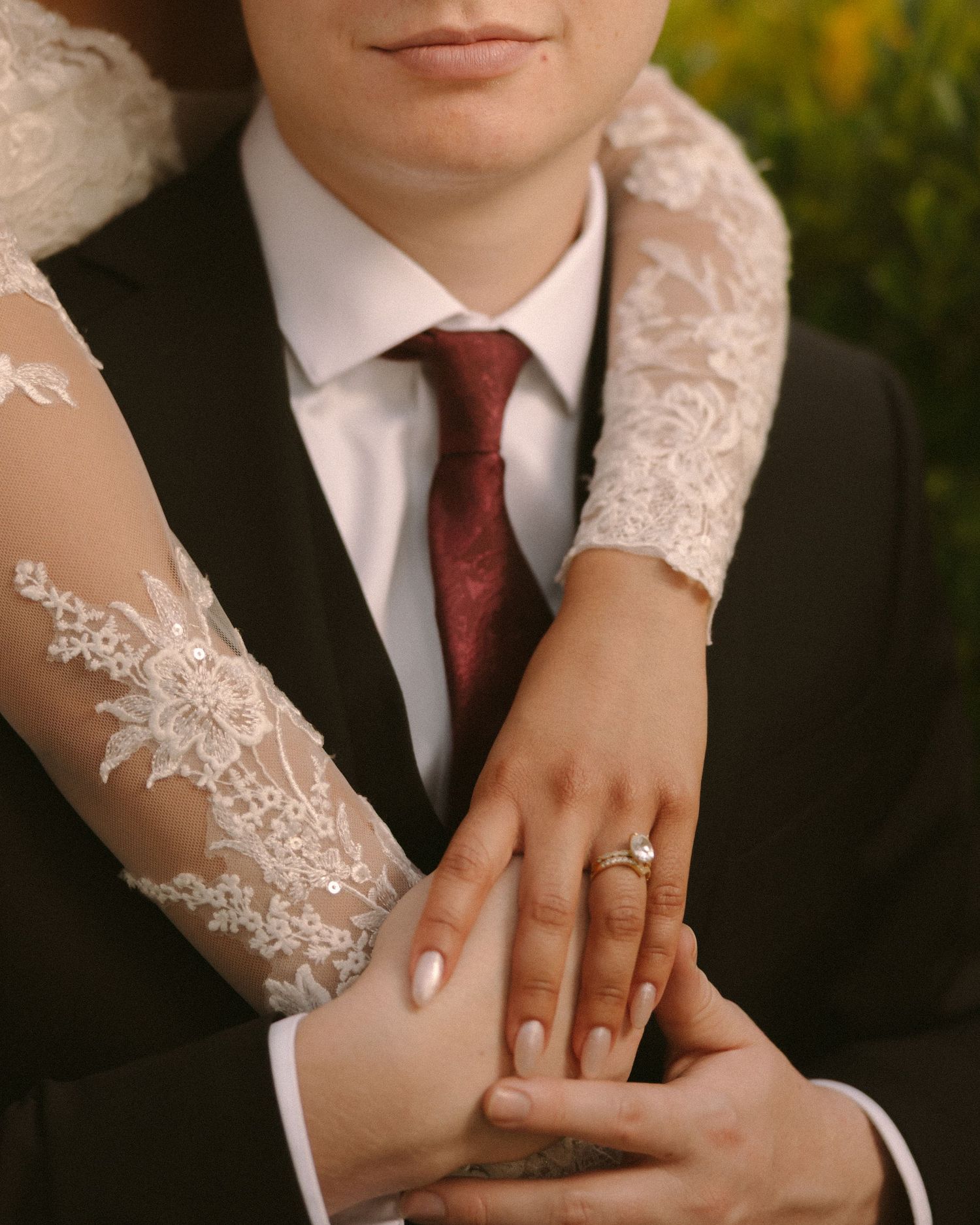 Bride and groom embrace in front of the venue, a timeless portrait with soft, natural tones.
