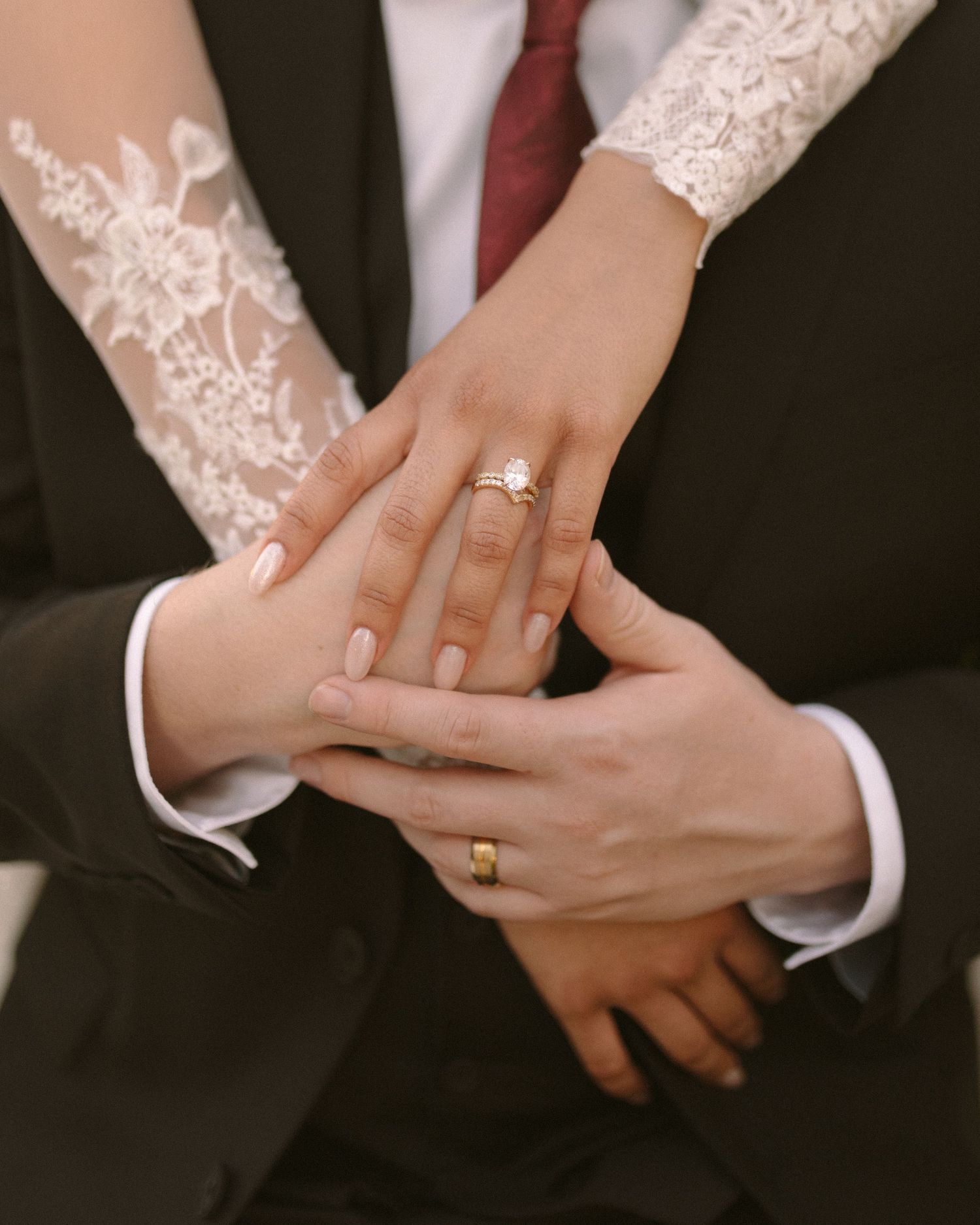 Bride and groom embrace in front of the venue, a timeless portrait with soft, natural tones.