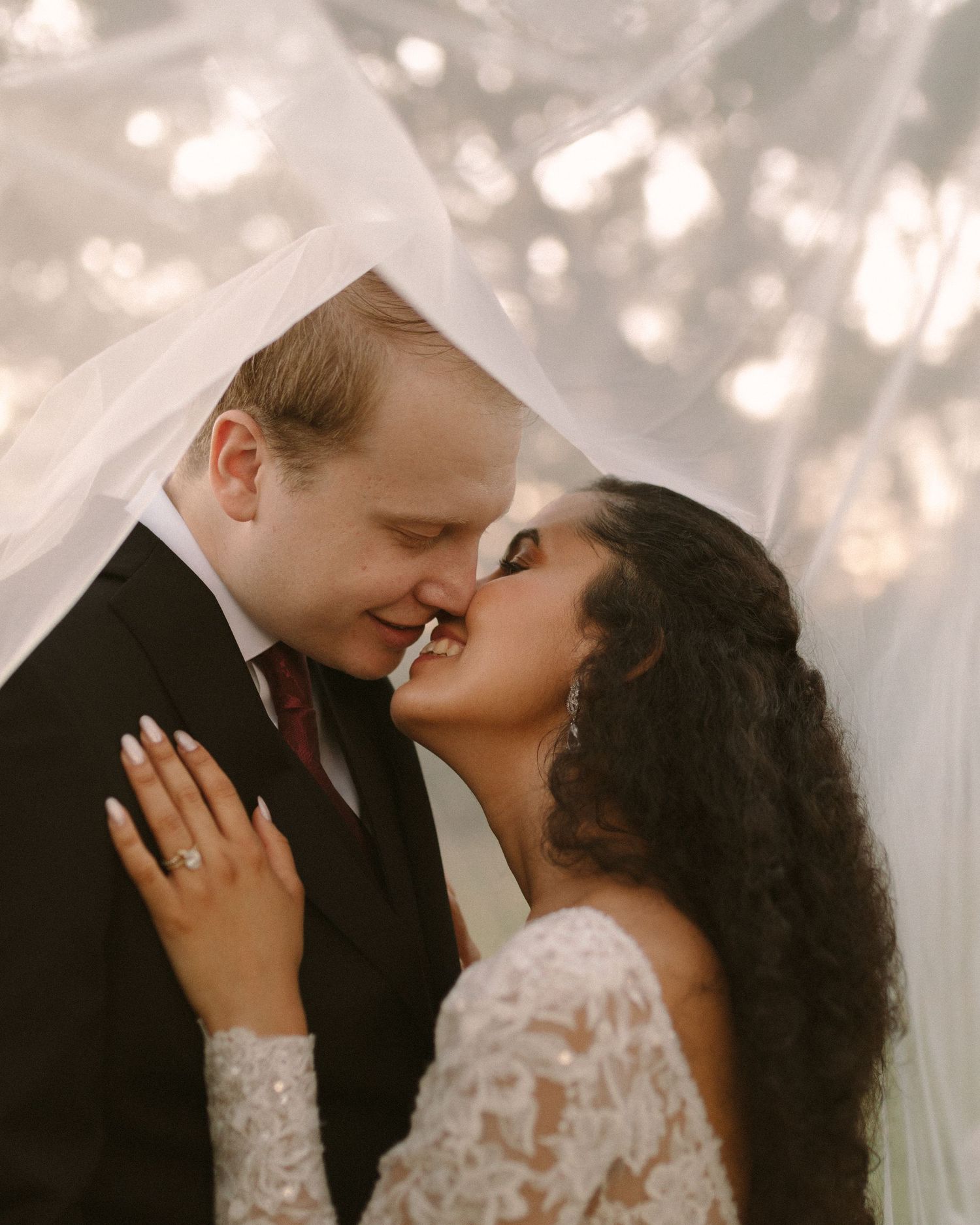 Newlyweds share their first kiss during the ceremony exit, surrounded by cheering guests.