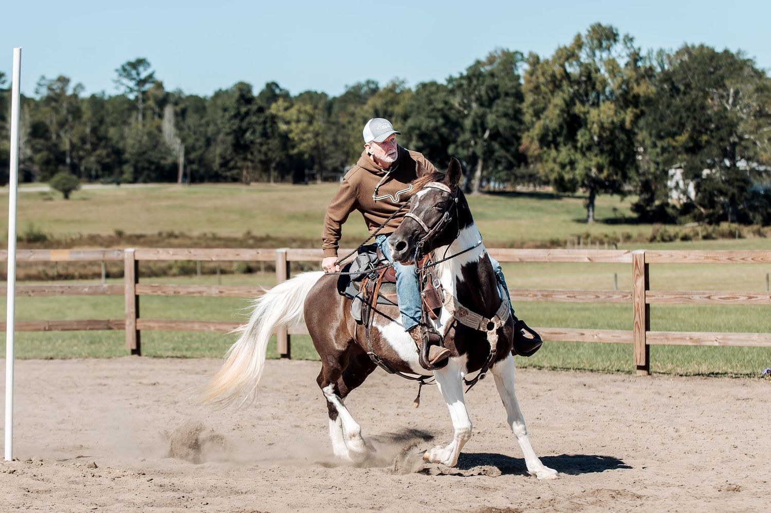 Western rider turning a brown-and-white paint horse around a pole during an equestrian event at Adams Family Fun Day in Warrenton, GA.