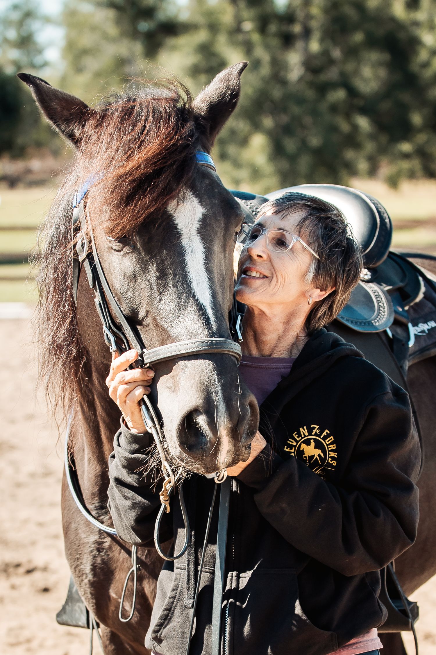 Woman sharing an affectionate moment with her horse at Adams Family Fun Day in Warrenton, GA, captured by Lace Cactus Photography.