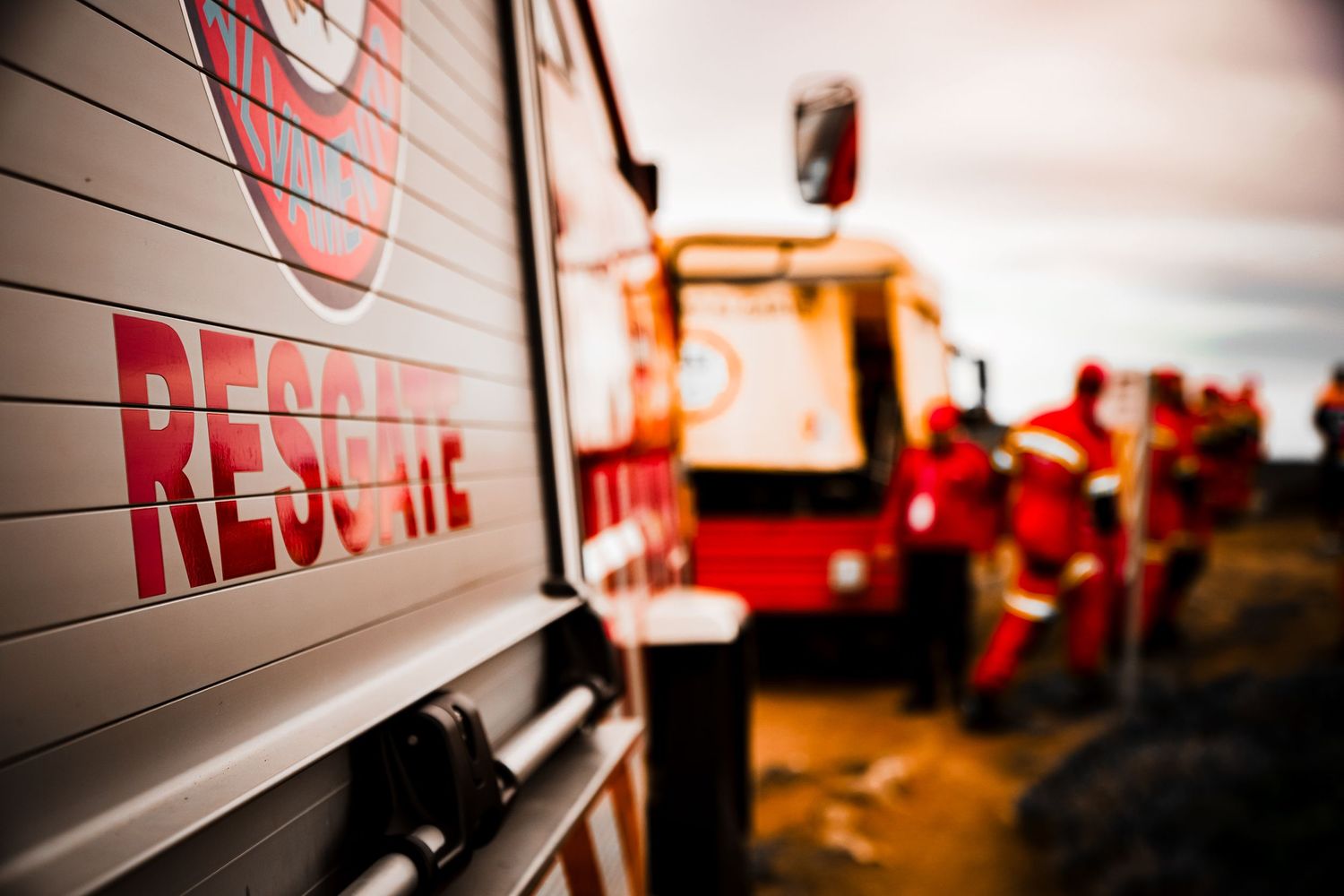 Close-up shot of a rescue vehicle with red lettering on its white side panel.