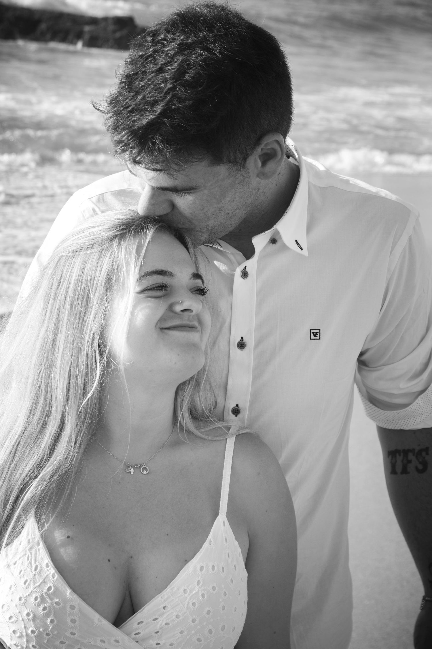 A black and white photo series showing a romantic couple sharing intimate moments together.