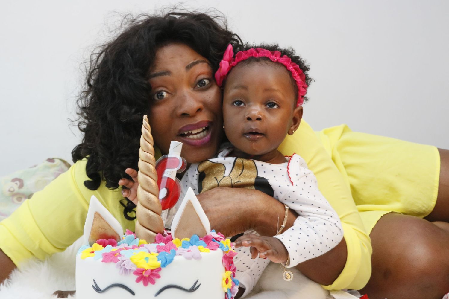 Birthday celebration scene with unicorn-themed cake and festive decorations.