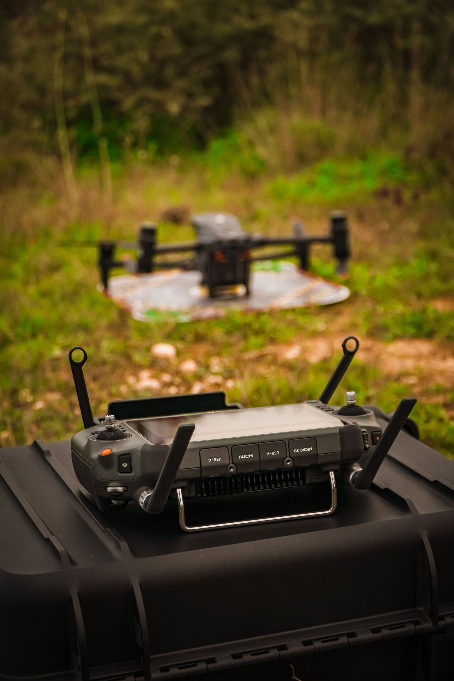 Close-up of black drone or remote control device components in natural lighting.