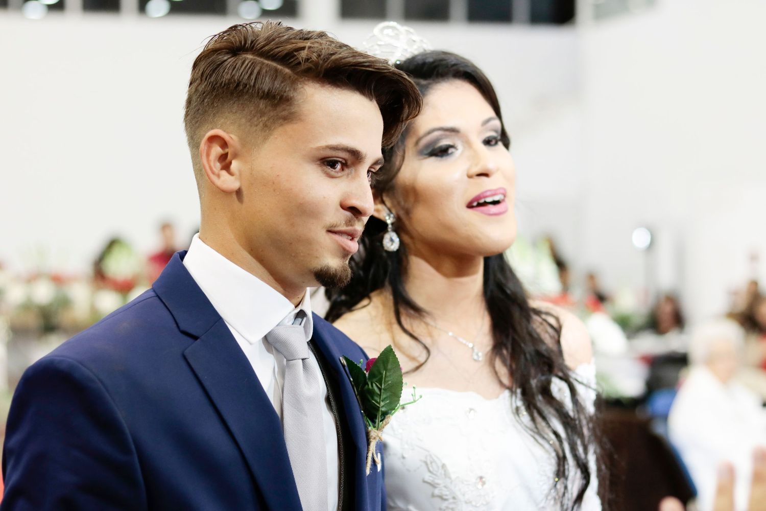 Elegant couple in formal wedding attire posing for portrait shot.