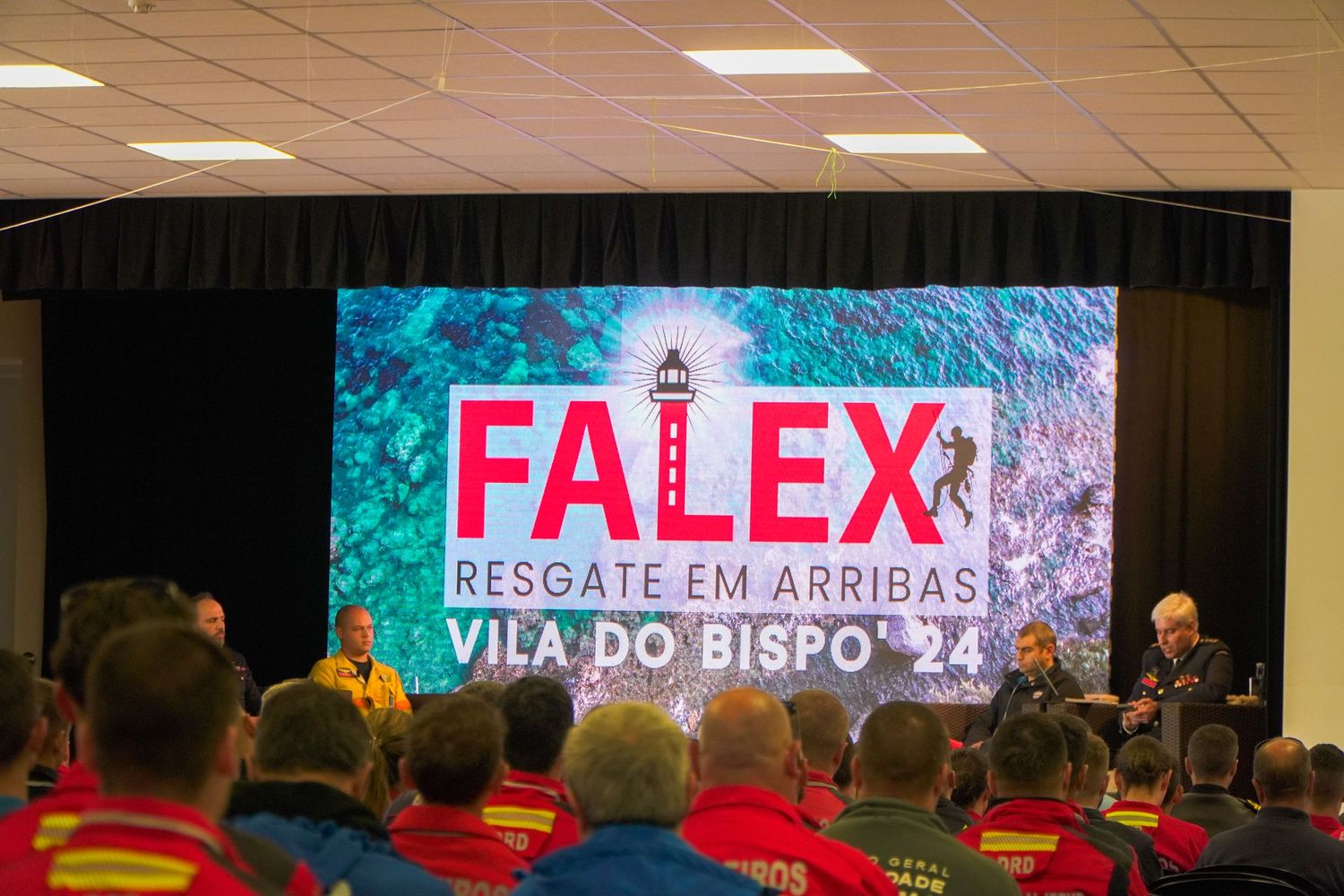 Conference room with LED screens displaying FALEX event branding.