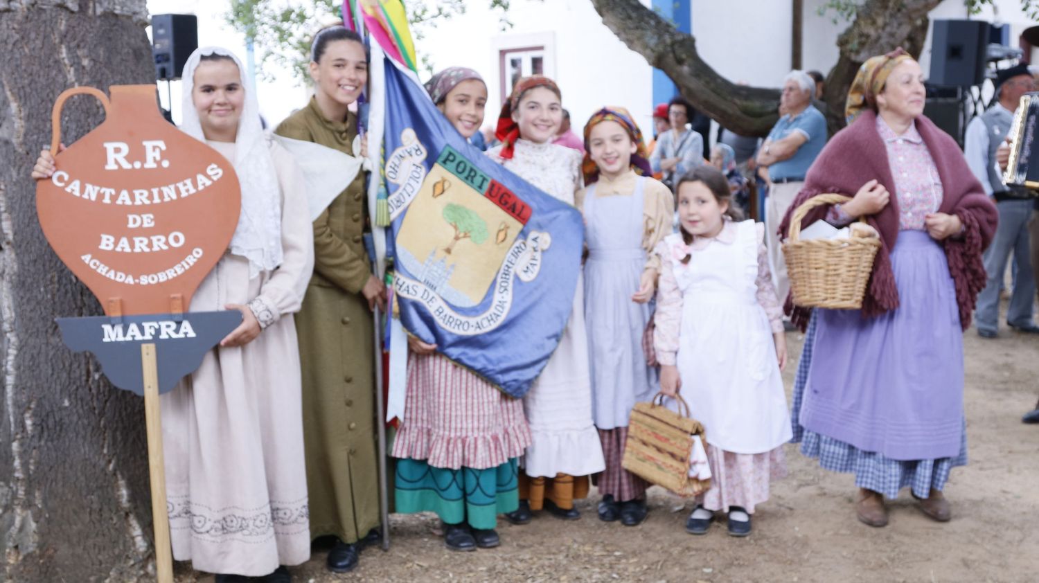 Children in costumes participating in an outdoor theatrical performance or parade.