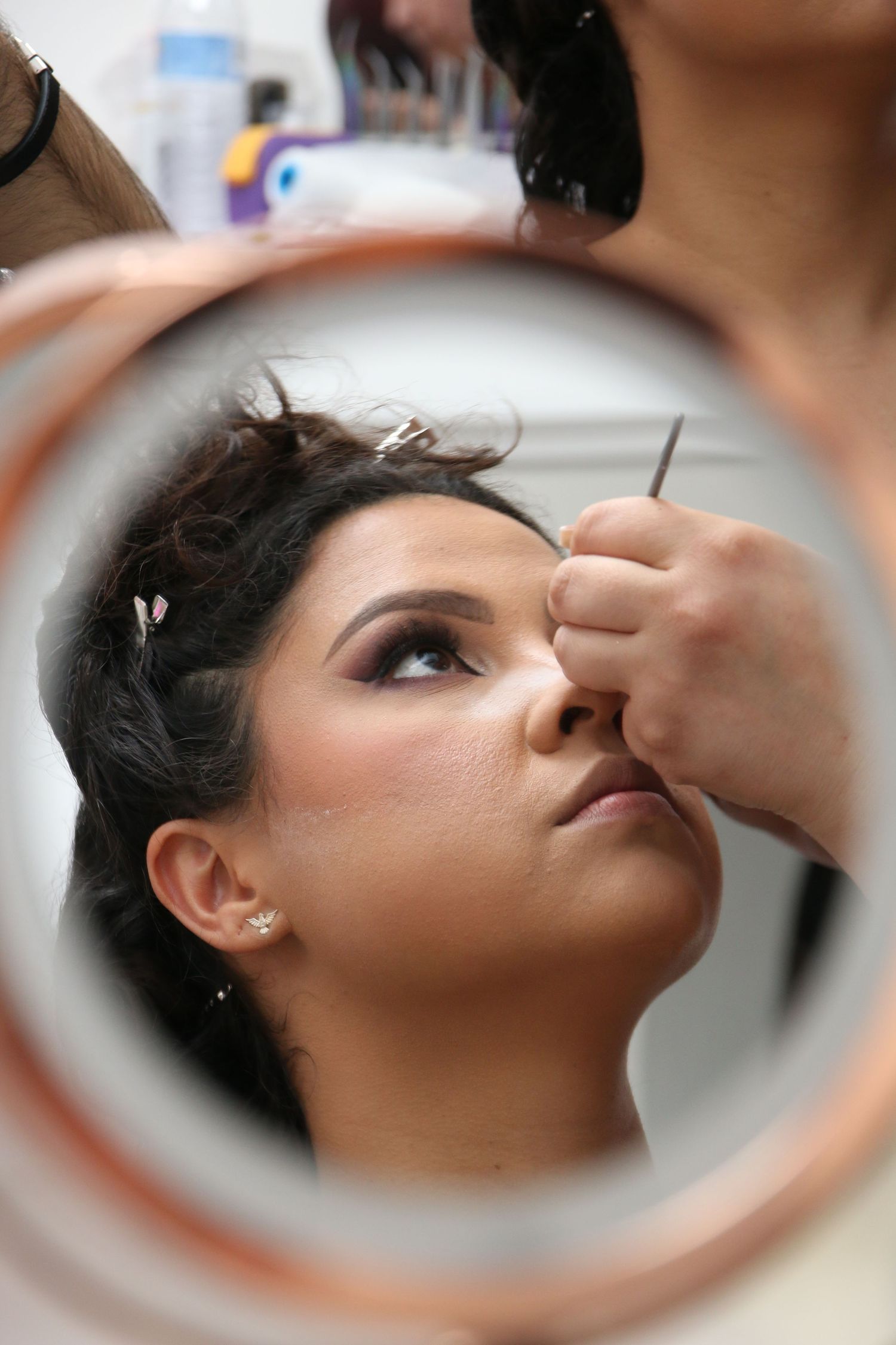 Close-up mirror reflection sequence showing eyelash application process and long lashes being applied.