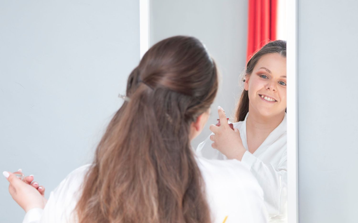 A reflection in the mirror shows wedding day preparations.