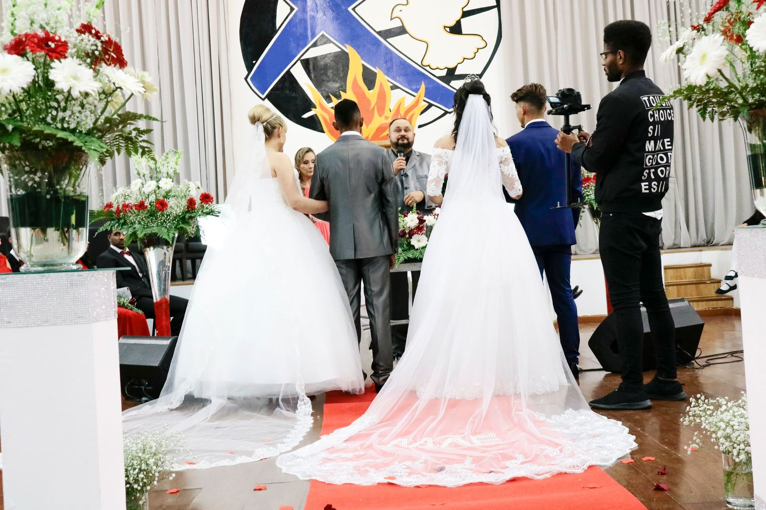 Wedding ceremony setup with white aisle runner and floral arch decorations.