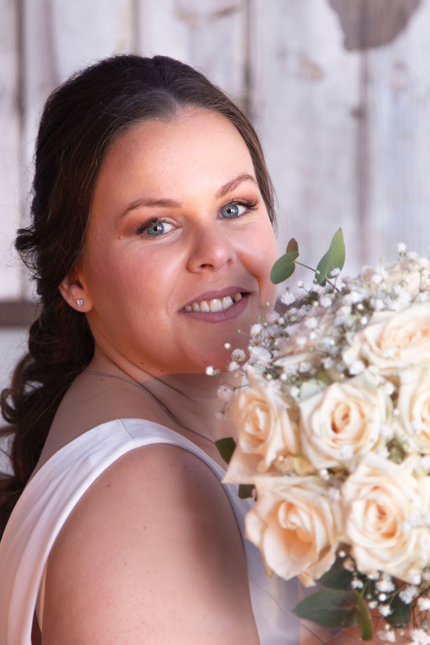 Bridal portrait with peach roses and baby's breath bouquet.