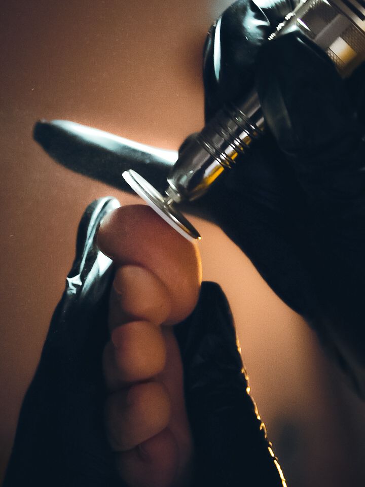Close-up shot of gloved hands preparing a spray bottle in atmospheric lighting.