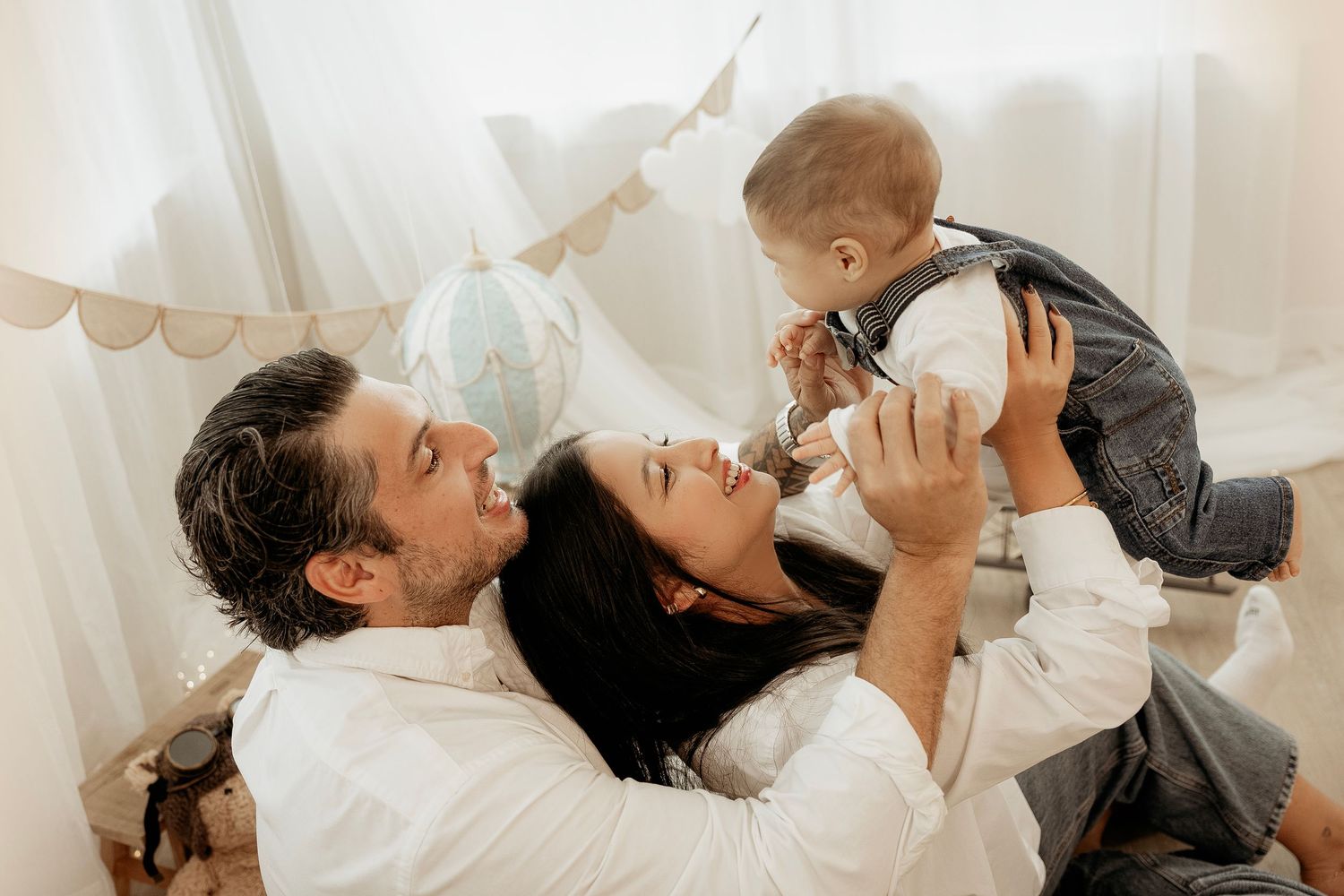 Parent feeding baby from bottle while lying on bed in sequence of tender moments.