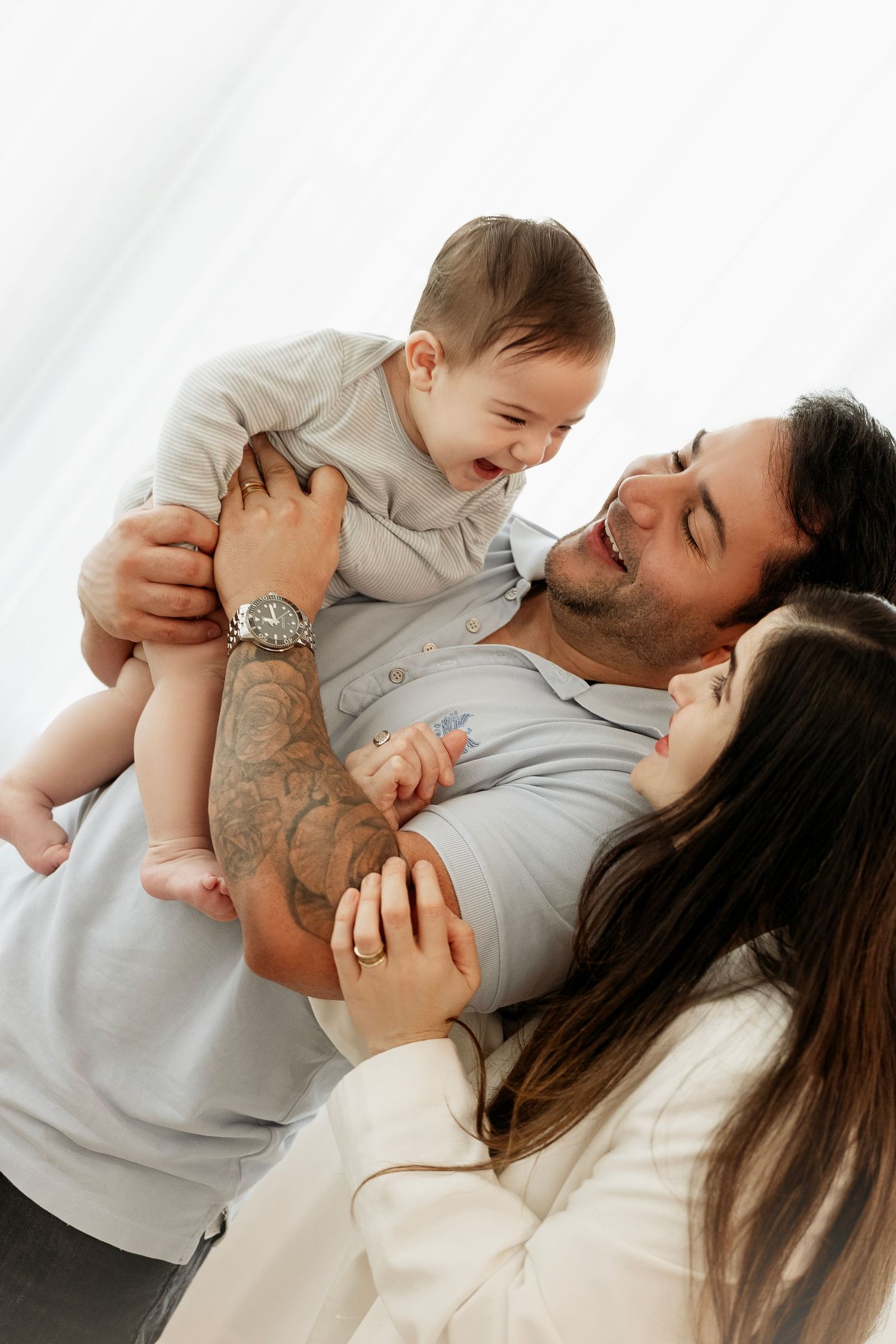 A parent and baby share tender moments of affection and play in a series of connected lifestyle photos.