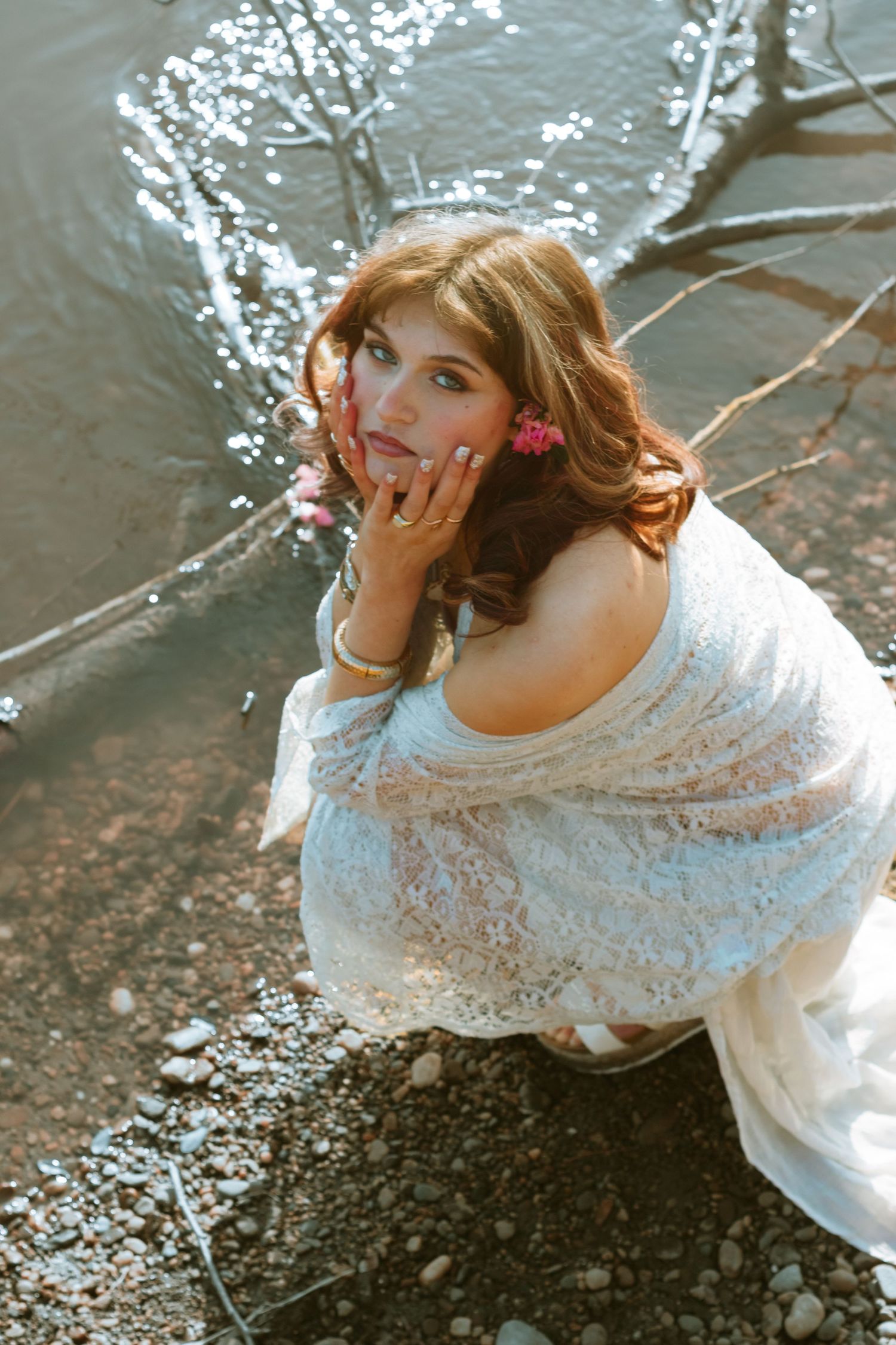 Ethereal portrait session featuring delicate white lace against a waterfront background.