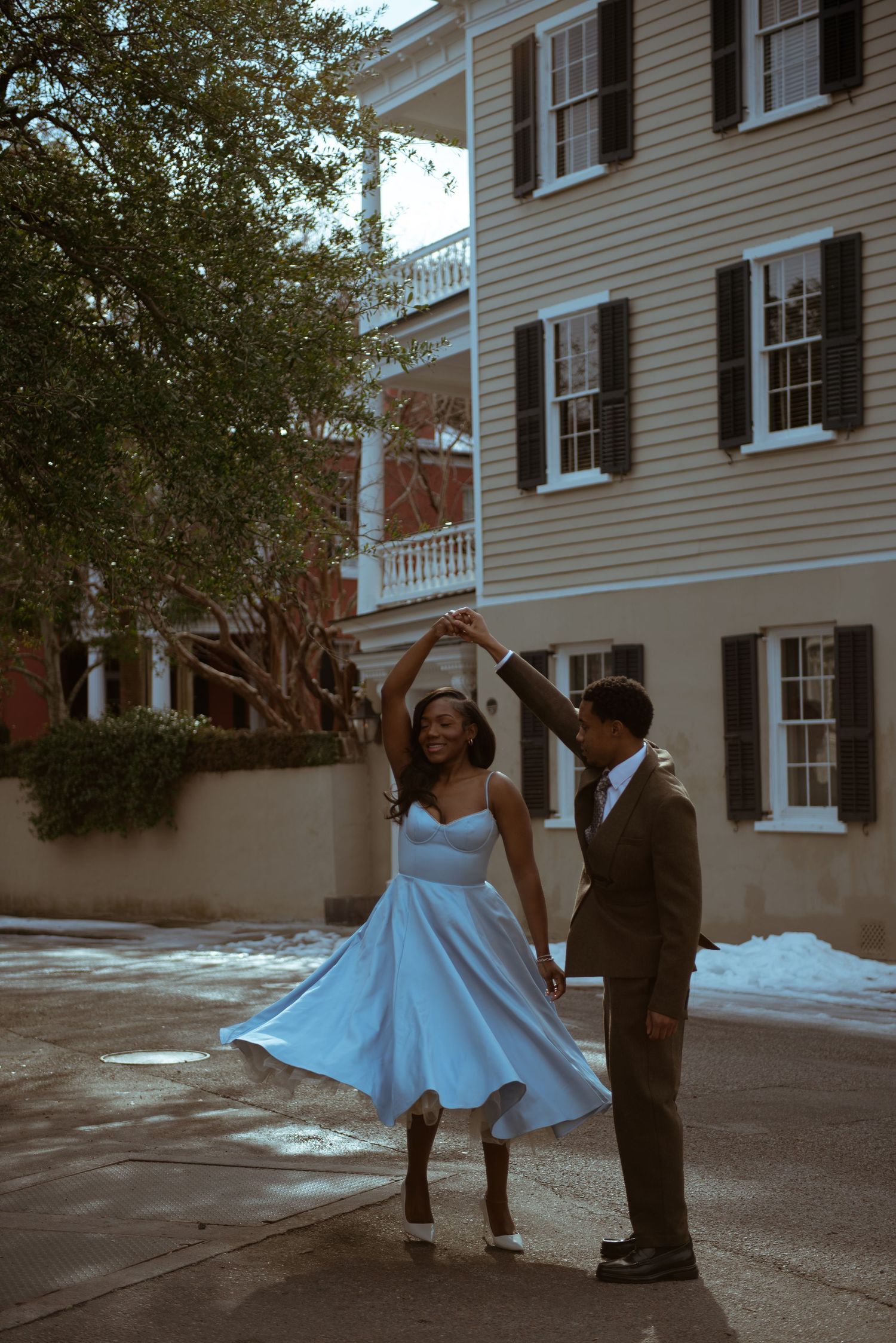 A couple is dancing together in the street in downtown Charleston, South Carolina.