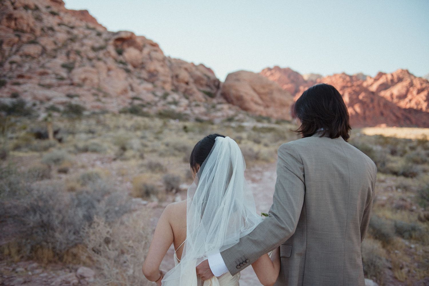 A couple are walking together in red rock canyon in Las Vegas.