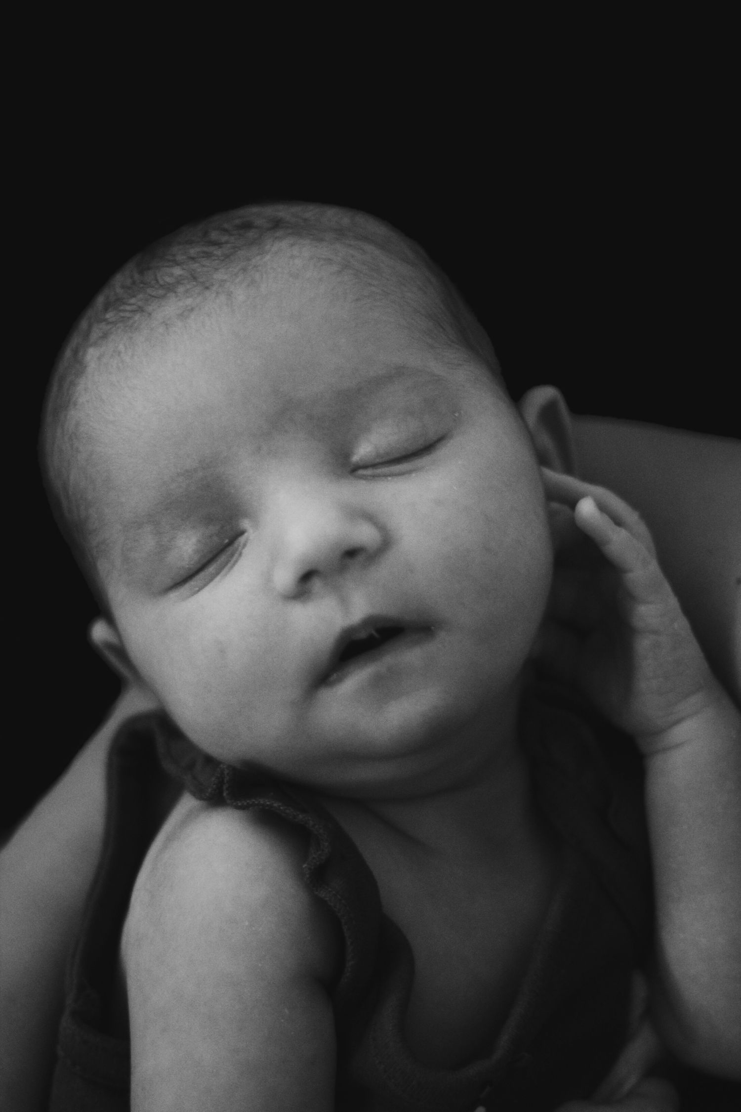 Close-up black and white portrait of a peaceful sleeping baby.