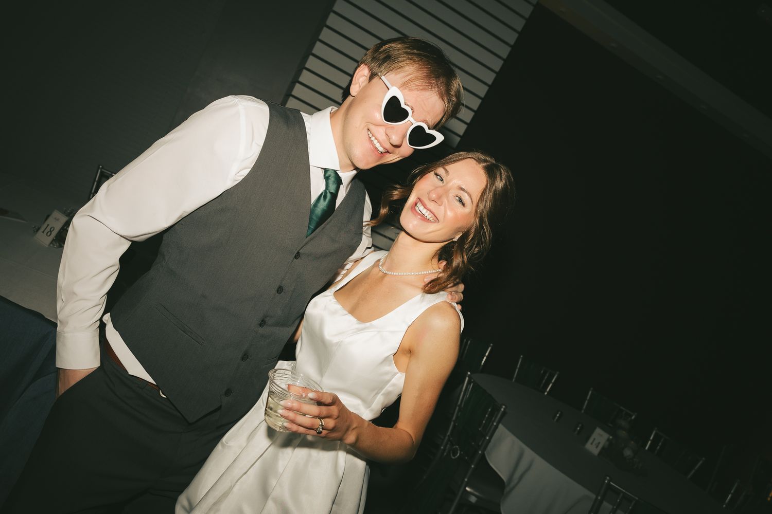 Guests enjoying themselves on a dimly lit dance floor at a wedding reception.