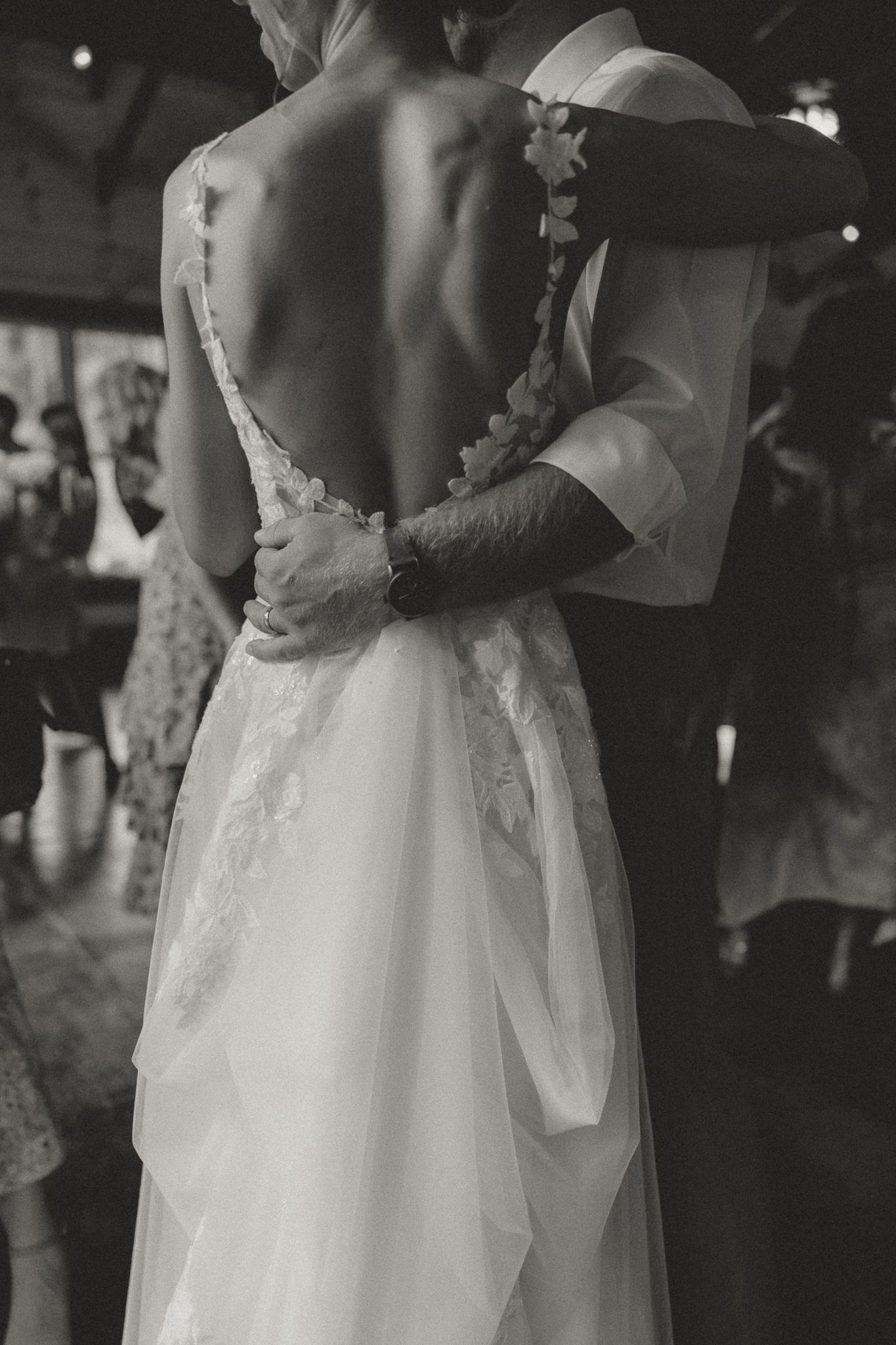 Couples slow dancing in an intimate moment at a wedding reception.