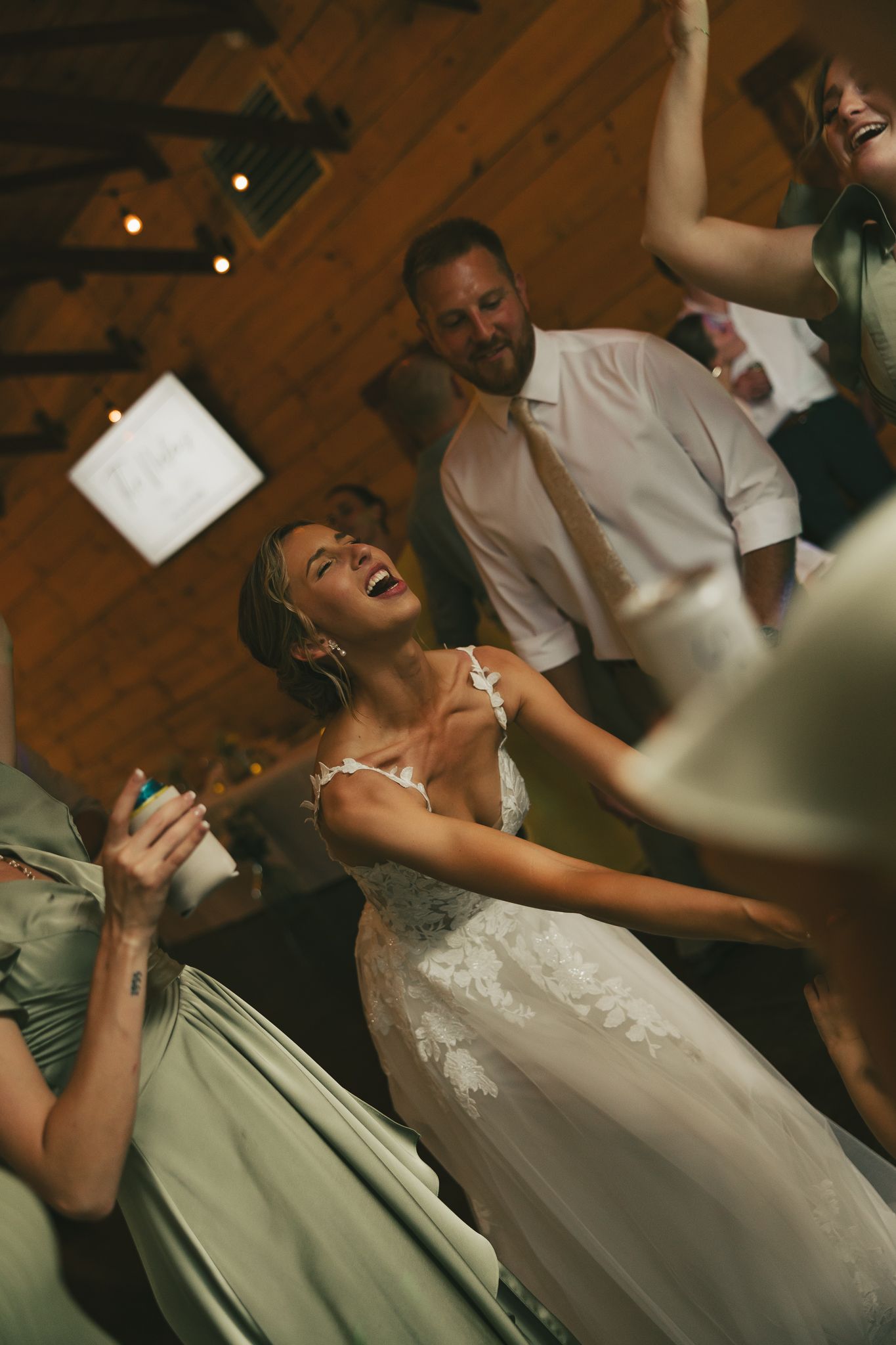 Joyful moments captured during a wedding reception with dancing and laughter.