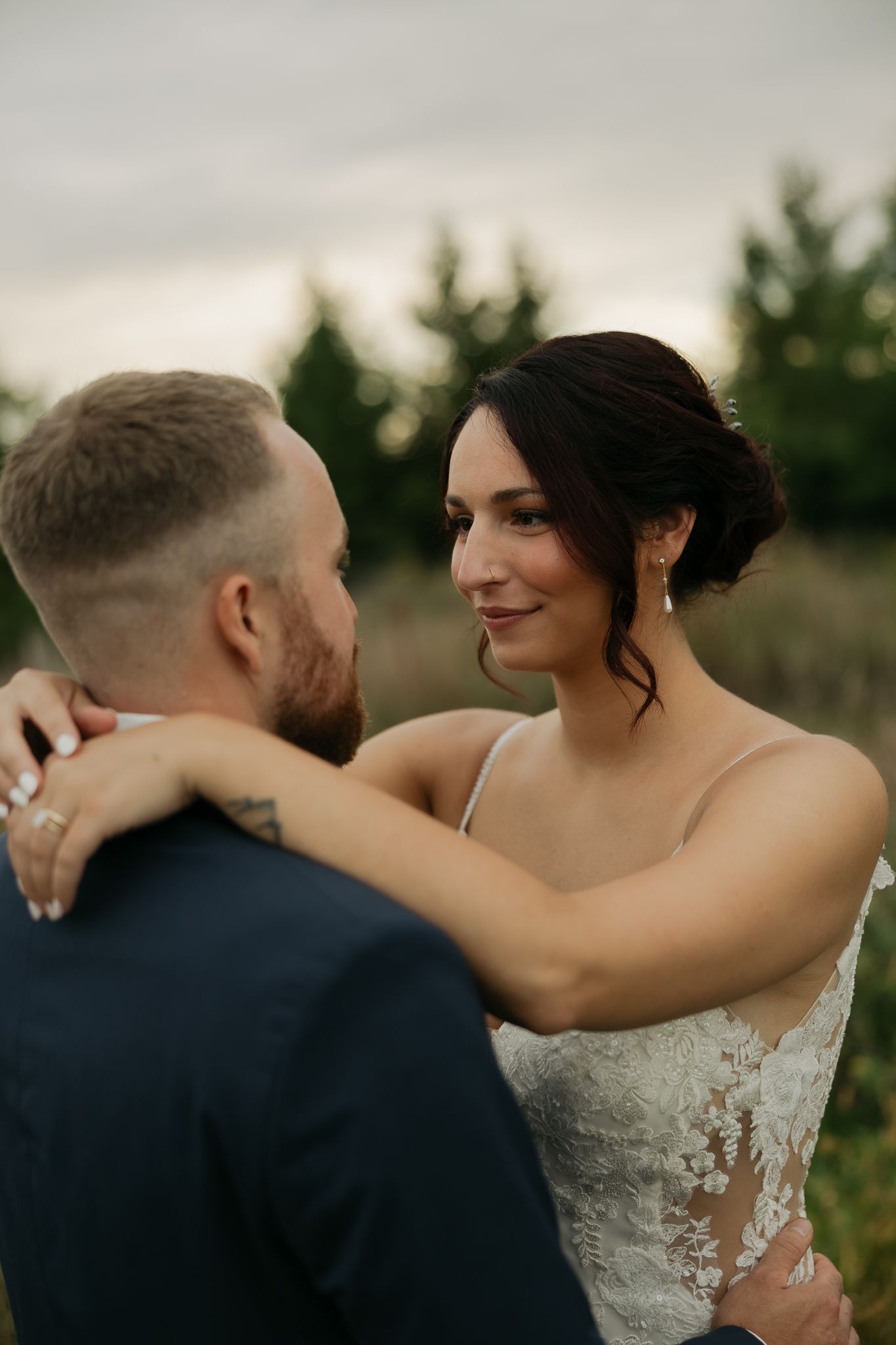Intimate wedding portrait of a couple sharing a tender moment at golden hour.