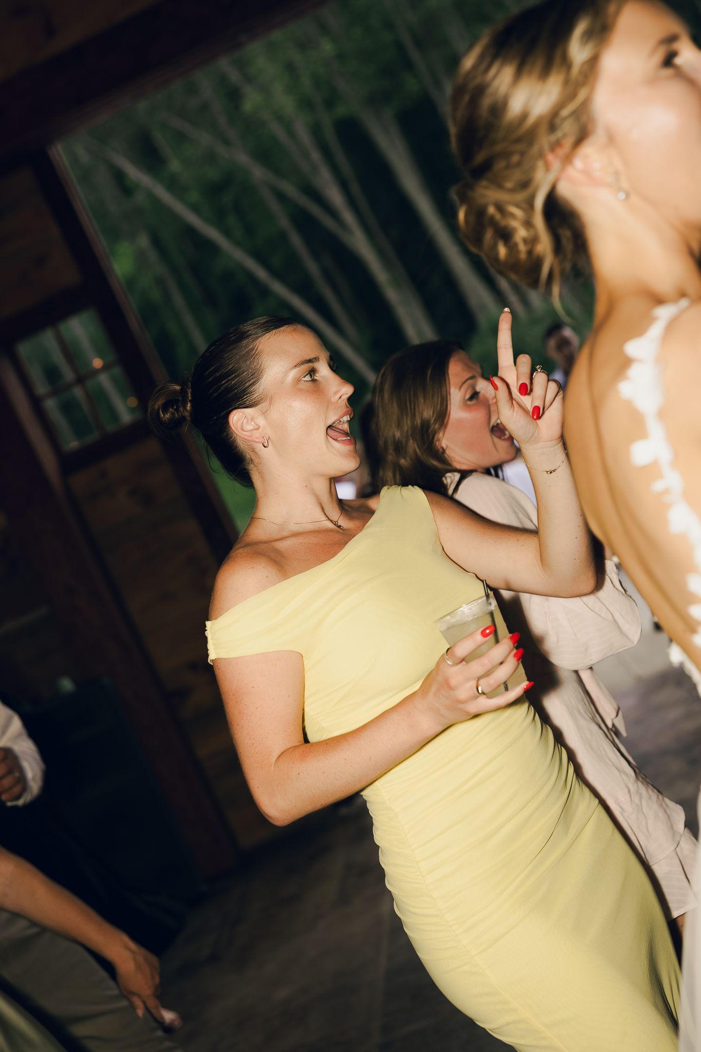 Energetic dancing sequence showing people enjoying themselves at a celebration in yellow attire.