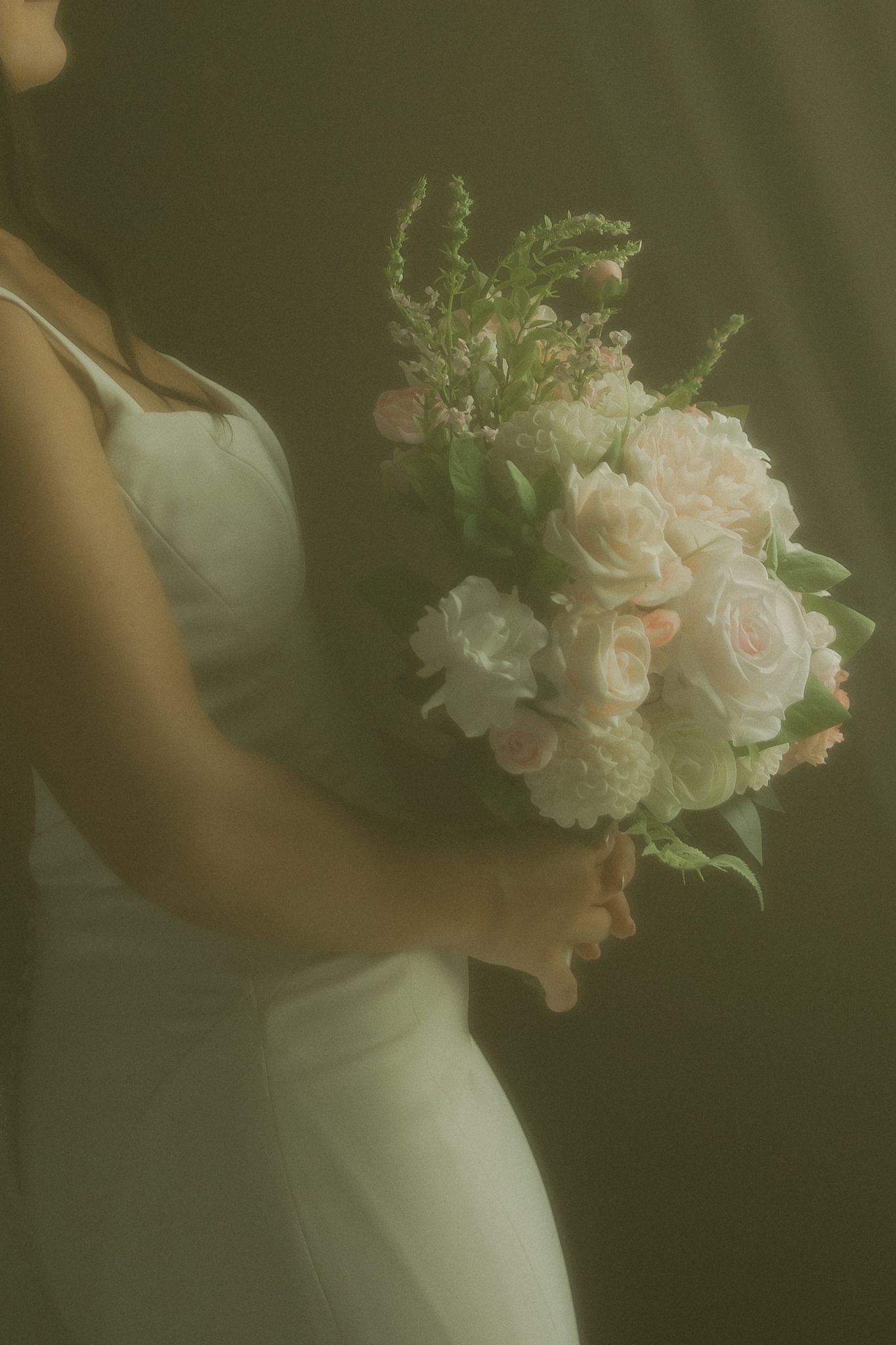 Soft focus shots of delicate pink and white bridal bouquet against green background.