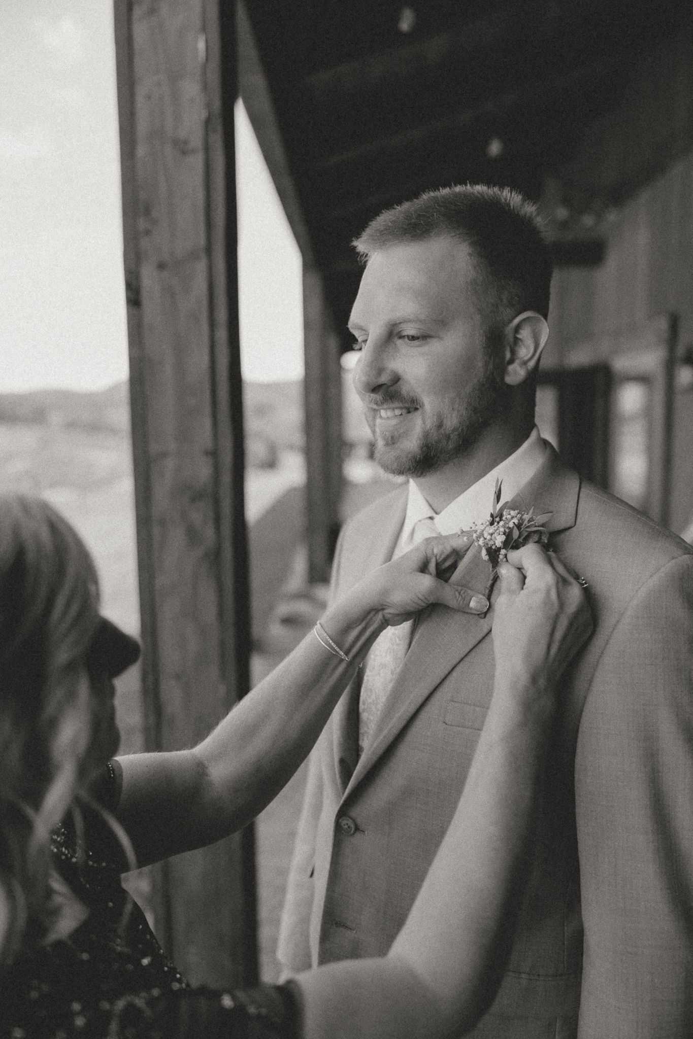 Black and white sequence showing final adjustments being made to formal attire.