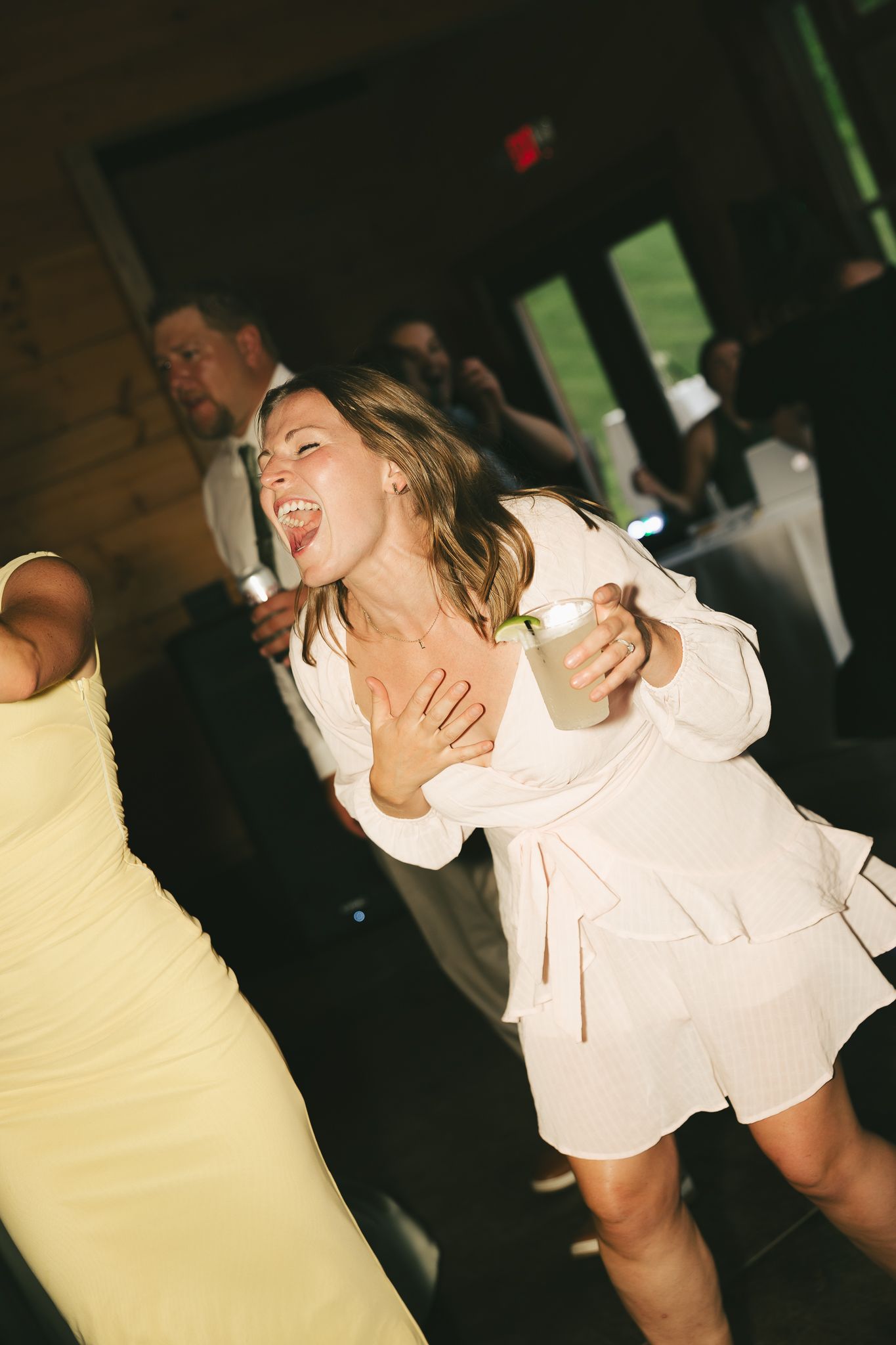 Sequence of energetic dance moves captured in a dimly lit reception venue.