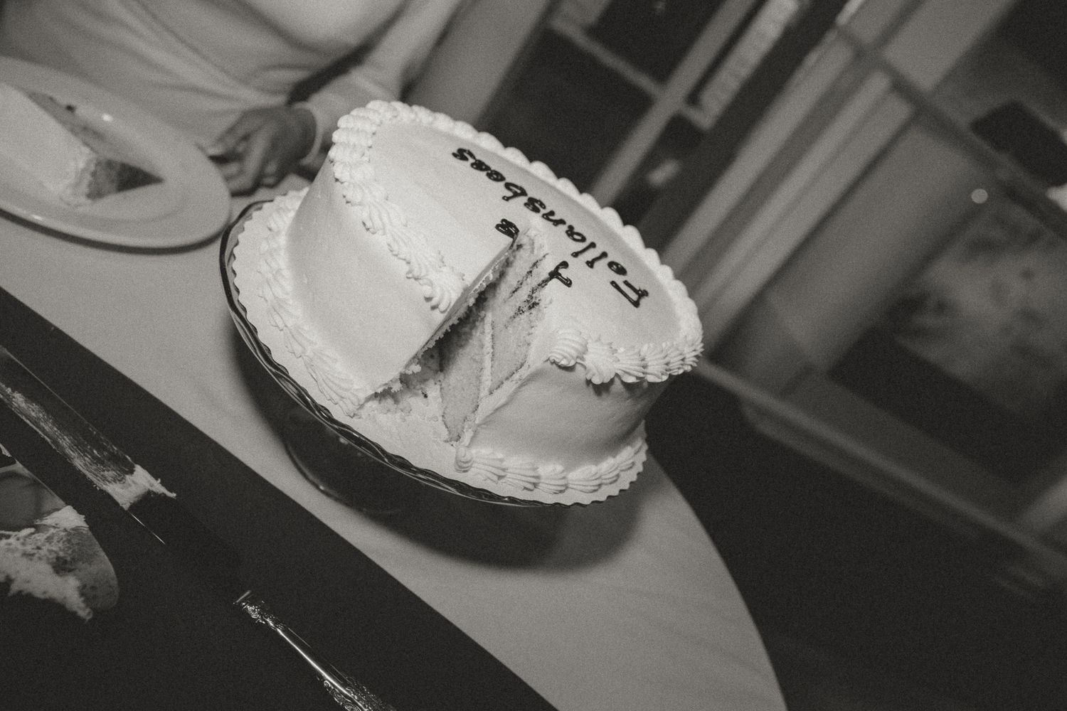 Black and white images of wedding cake being served at reception.