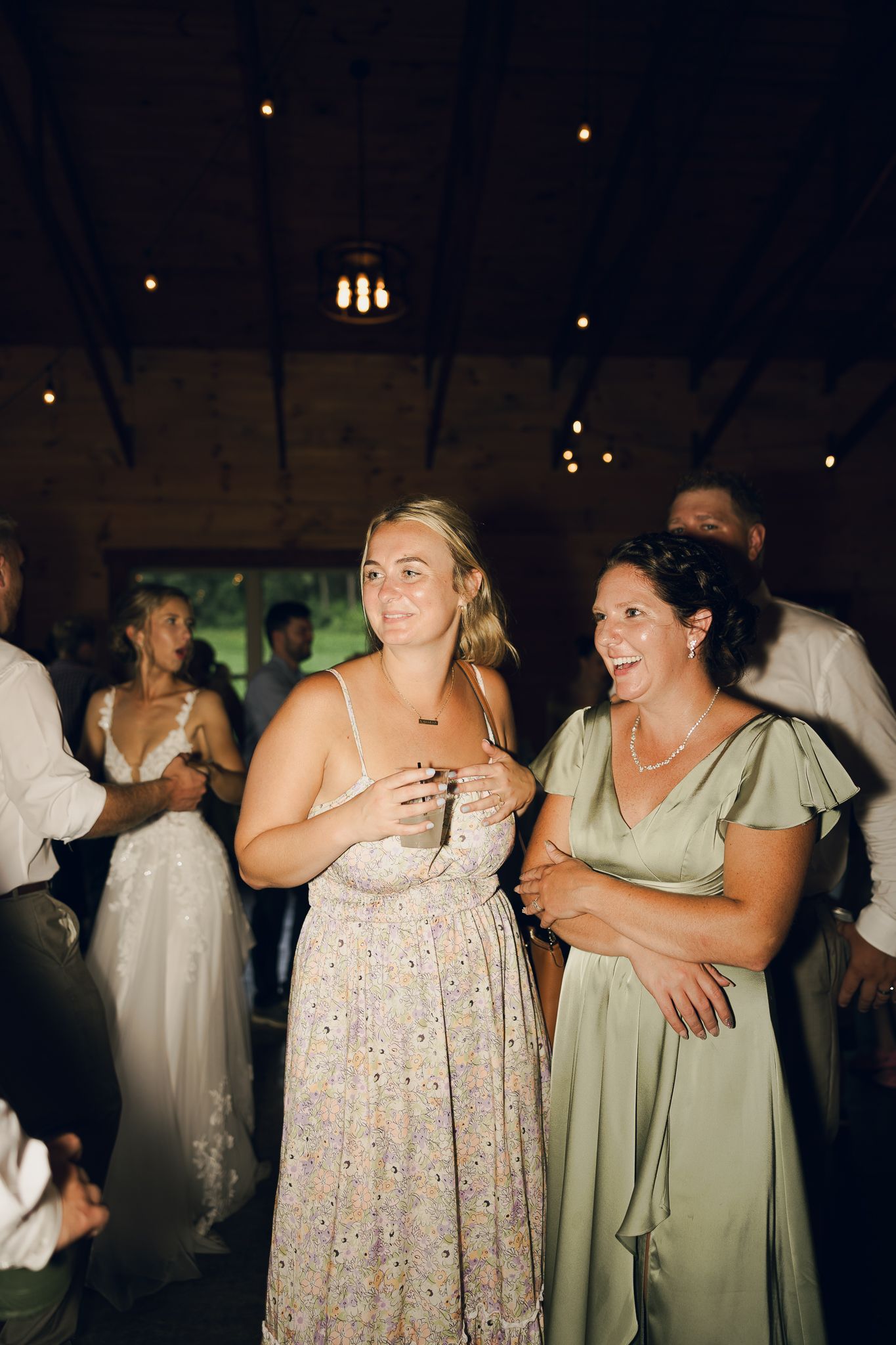 Wedding guests enjoying themselves on the dance floor during an evening reception.