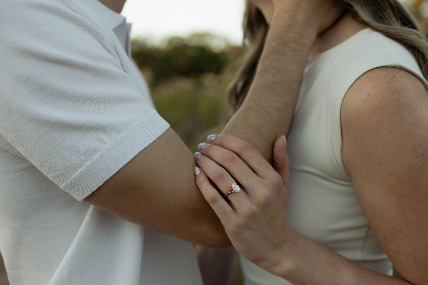 Intimate close-up of couple's hands embracing outdoors.