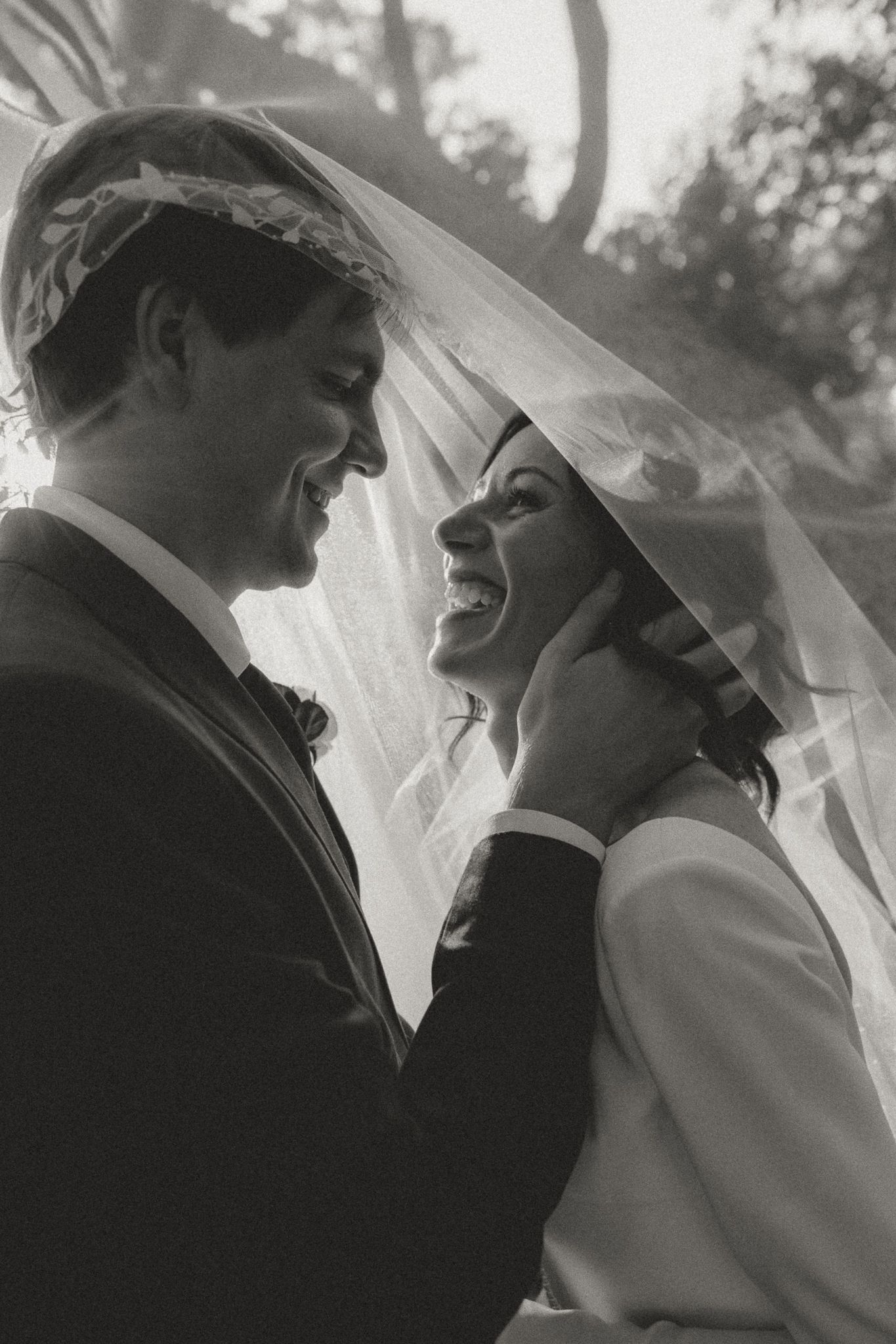 Artistic black and white close-up of newlyweds sharing a tender moment.