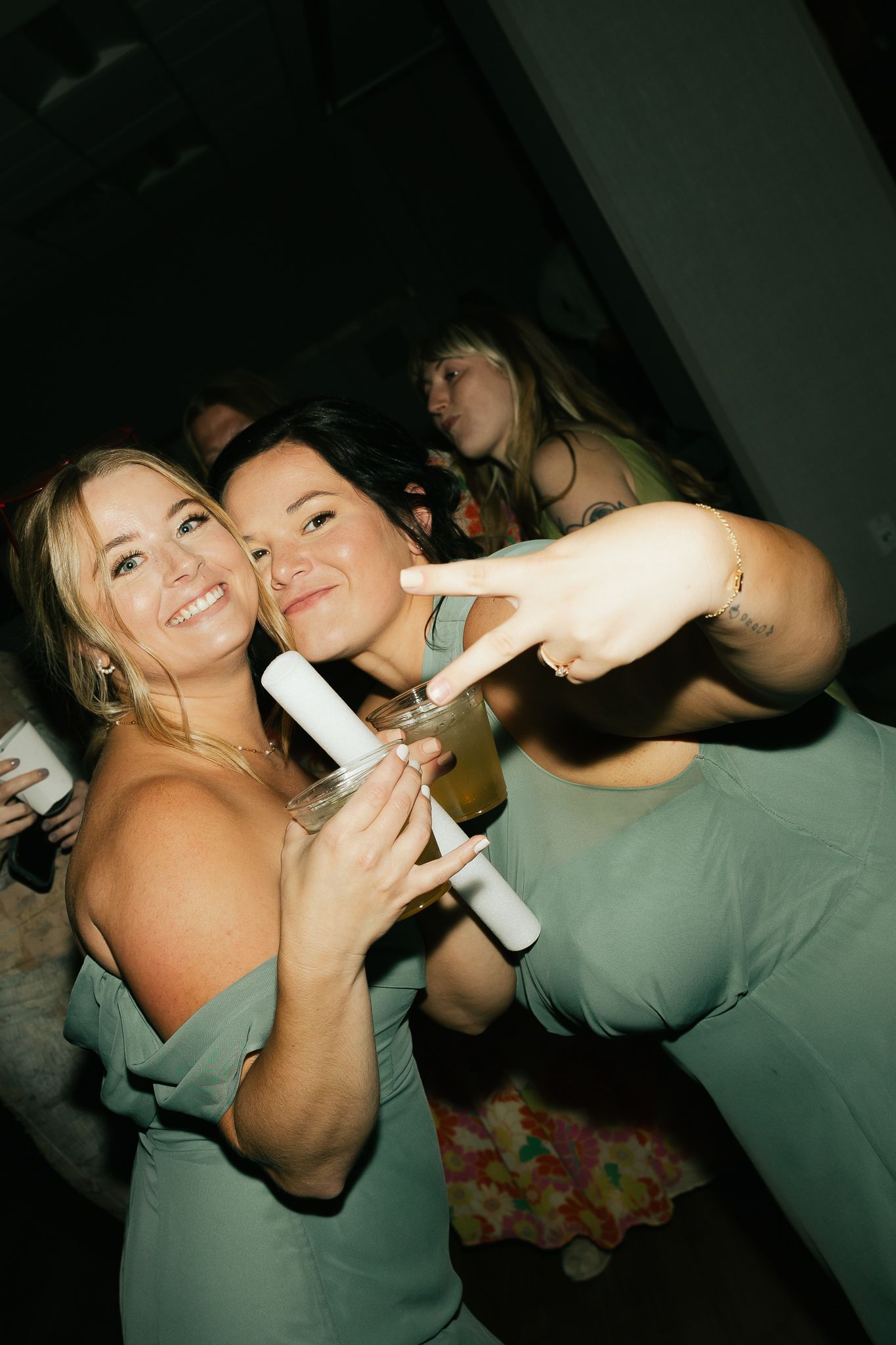Party guests in formal attire dancing and posing together.