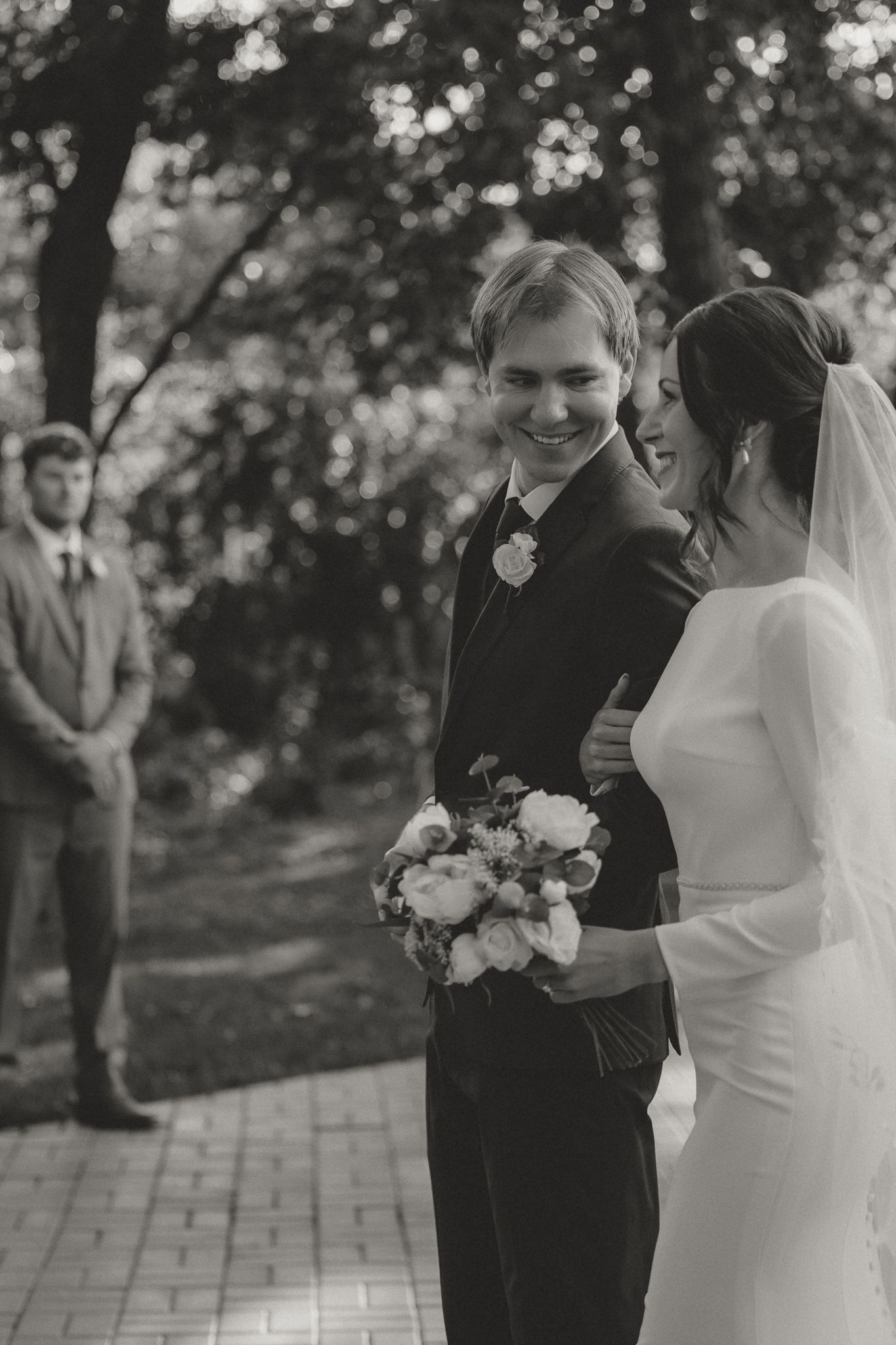 Black and white wedding portraits captured in a natural outdoor setting.