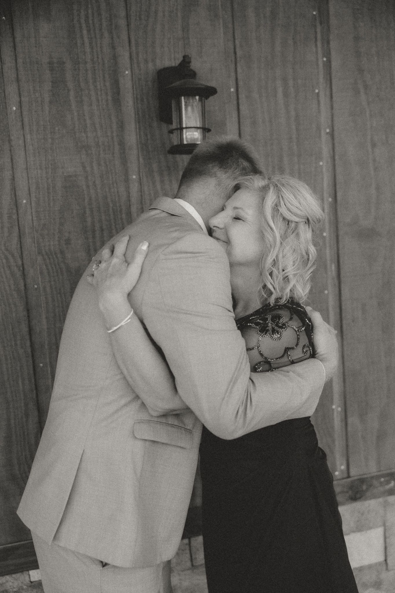 Black and white sequence showing an emotional embrace at a formal event.