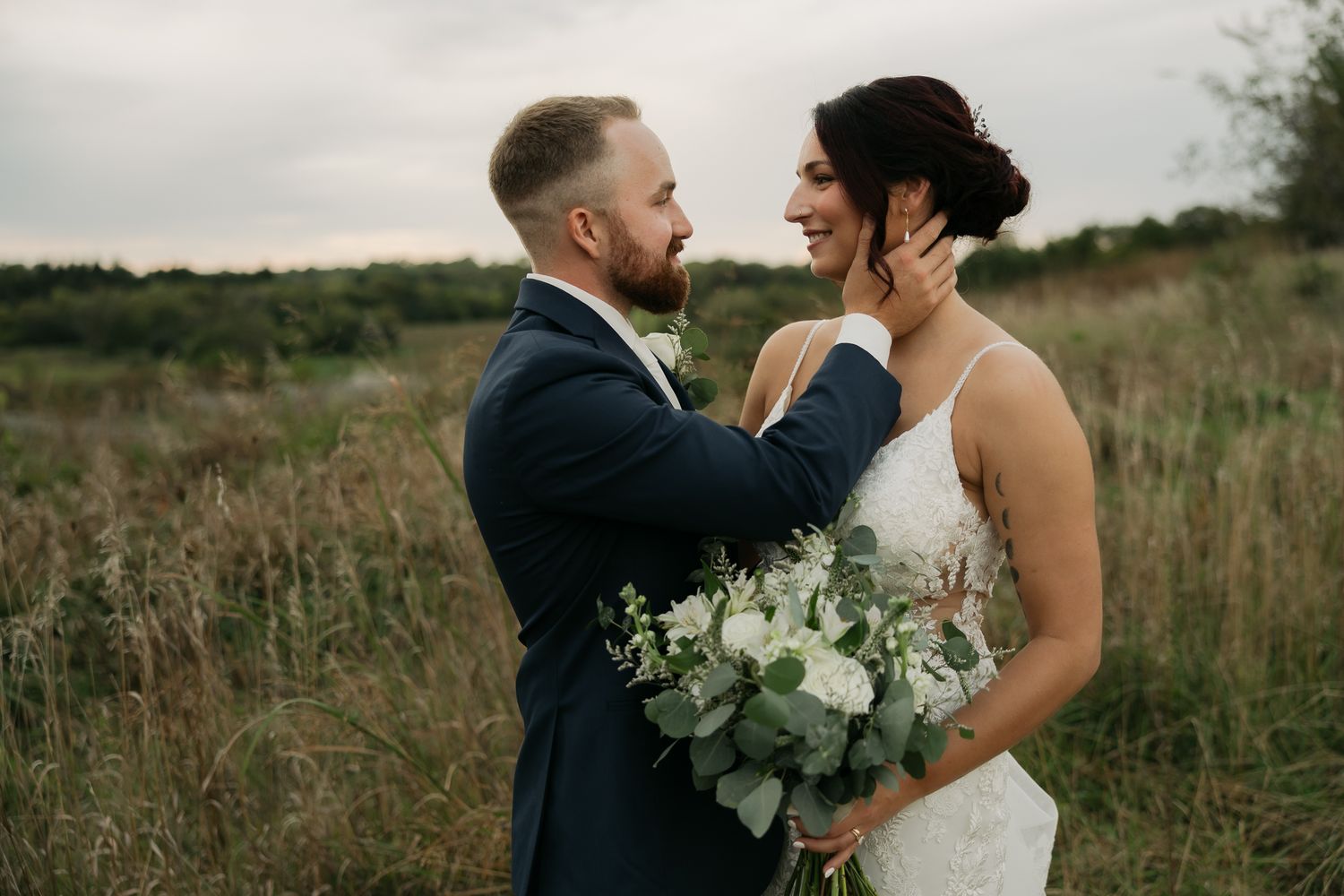 Romantic wedding portraits captured against natural outdoor backdrop with greenery.