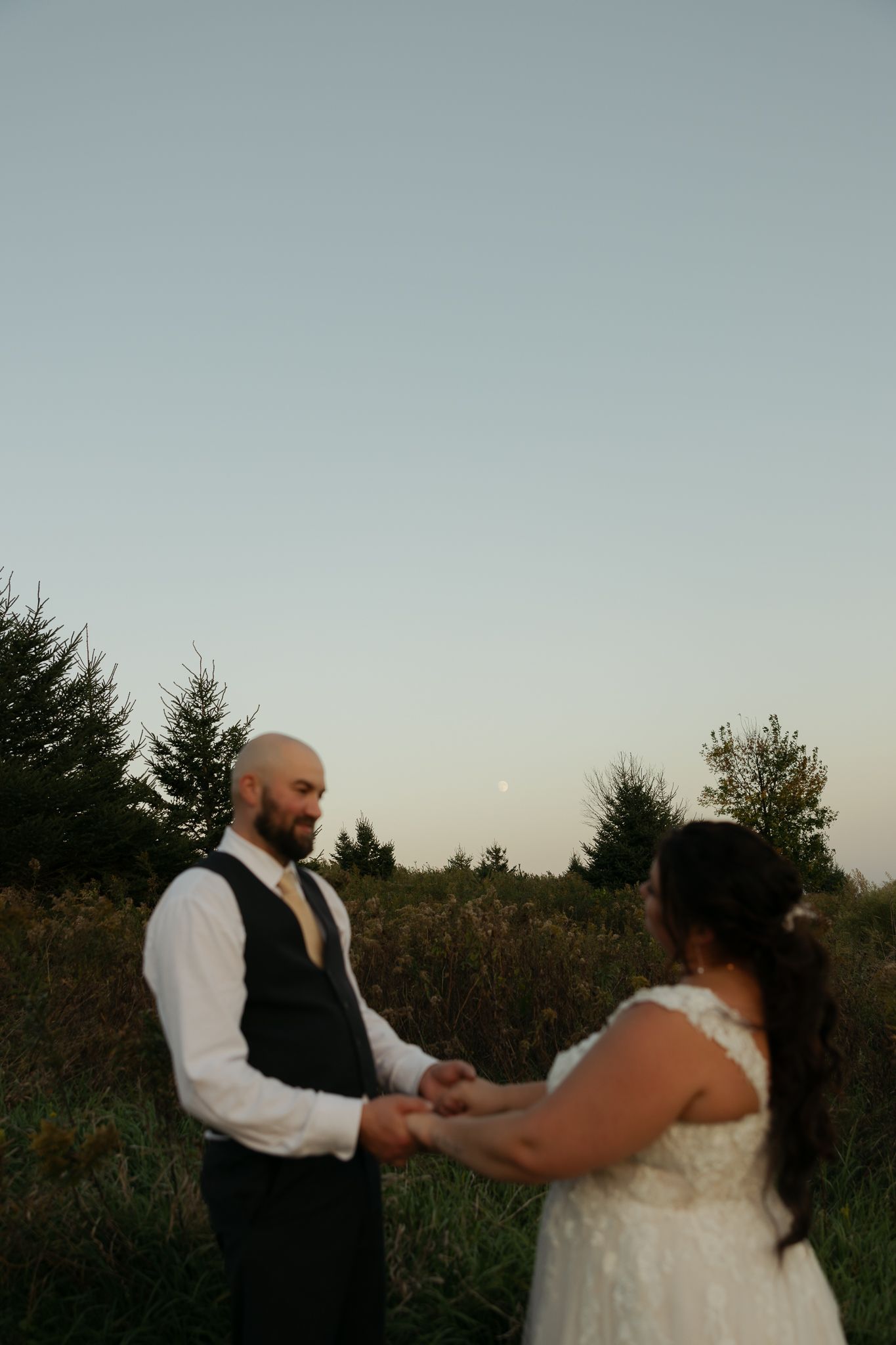 Couple dancing together at sunset in outdoor setting.